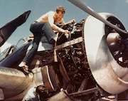 Aboard the USS Lexington (CV-16) in early December 1943 an Aviation Machinist Mate First Class works on a Hellcat’s Pratt & Whitney engine during fleet operations against the Japanese. The photographer, Cmdr. Edward Steichen, was well-known in the civilian world, but like many successful individuals from baseball players to artists, writers and movie actors, he added his talents on active duty with American branches. The original carrier Lexington was sunk at the Battle of the Coral Sea in May 1942. Typically, the Navy named another ship in honor of the one lost and to carry on its traditions.