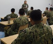 NORFOLK, Va. (June 17, 2024) Capt. Riley Murdock, commanding officer of Surface Combat Systems Training Command Hampton Roads, addresses Aegis Tactical Action Officer (ATAO) students in the Reconfigurable Combat Information Center Trainer (RCT) onboard Naval Station Norfolk.  Students in the nine-week ATAO course execute realistic, relevant, and complex scenarios in a threat environment that they may face at sea in the RCT. (U.S. Navy photo by Electronics Technician 1st Class Cassondra Johnson)