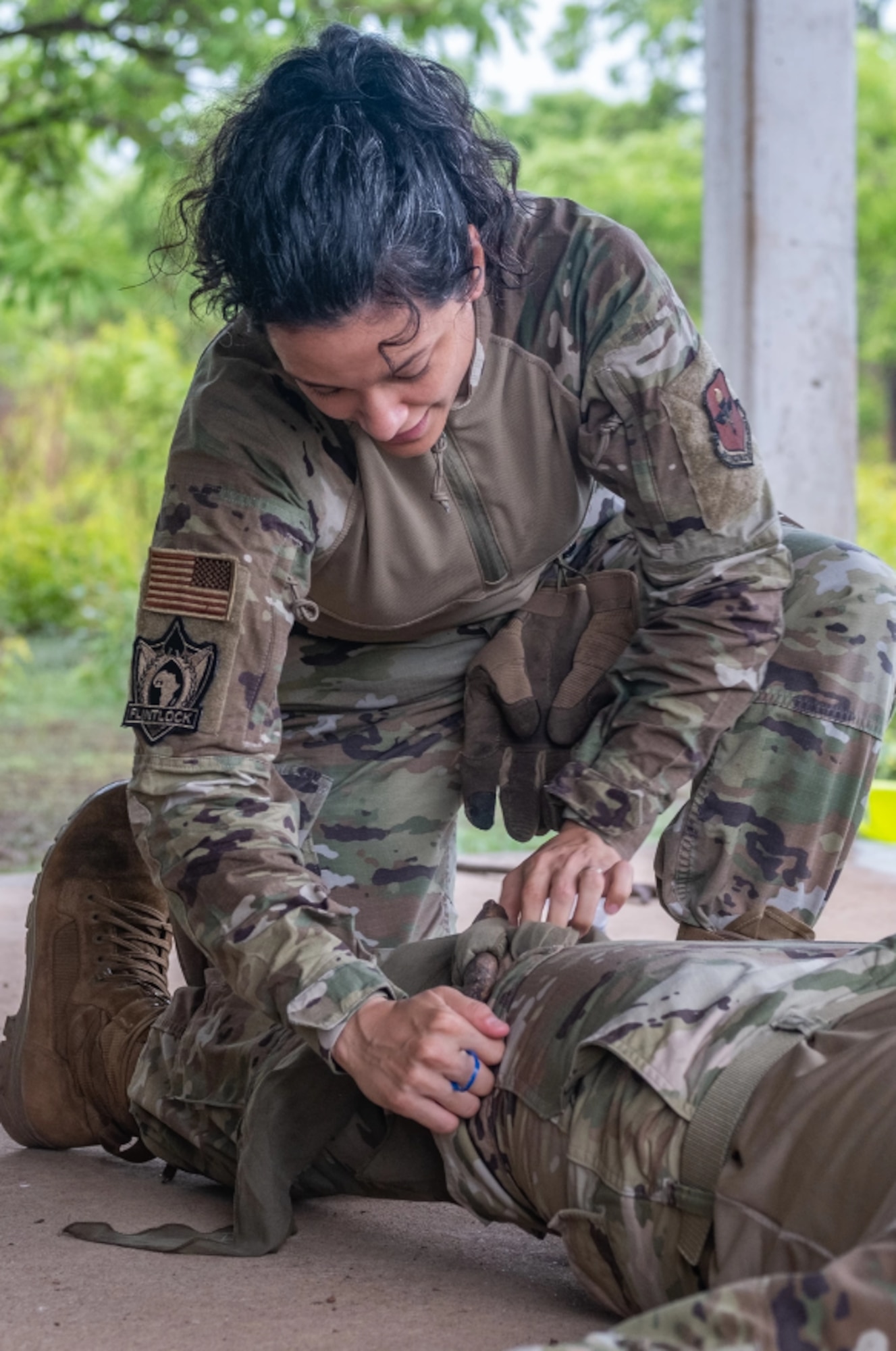 U.S. Air Force Capt. Sabrina Torres, a clinical nurse assigned to 71st Medical Group, demonstrates an improvised tourniquet in a Tactical Combat Casualty Care training during Flintlock 24 at Daboya, Ghana, May 13, 2024. This year’s exercise builds on the success of previous iterations of Exercise Flintlock and focuses on the transition from tactical execution to operational planning and multi-domain integration. (U.S. Army National Guard video by Spc. Kevin Brown)