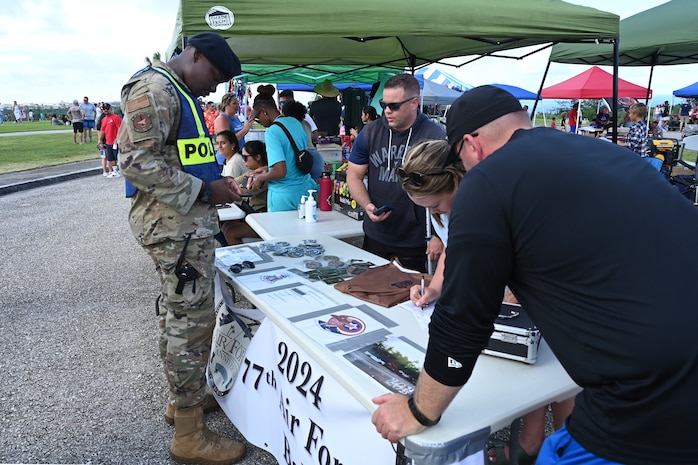 A 36th Security Forces Squadron member observes the Air Force Ball Committee's items.
