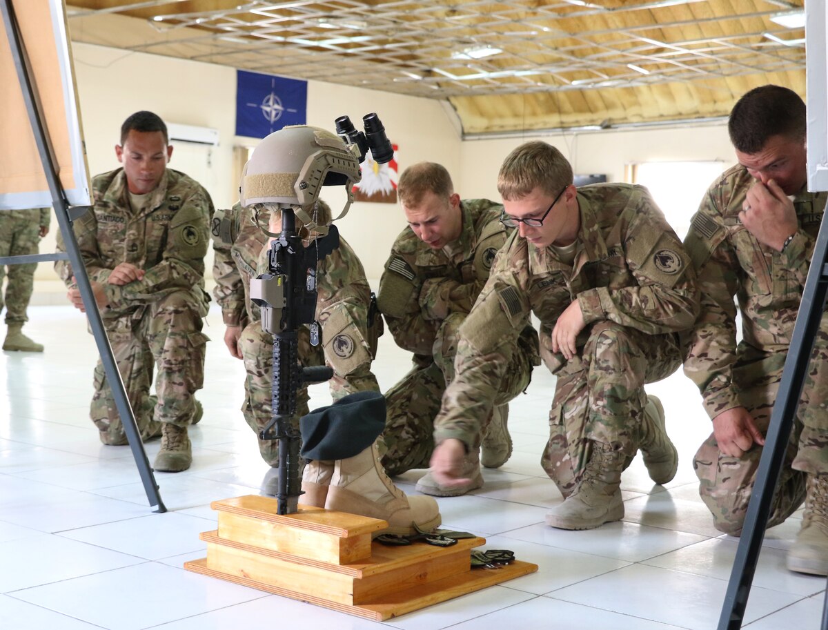 Soldiers and teammates of 1st Sgt. Peter "Drew" McKenna, Jr. pay tribute to him during a memorial at Camp Integrity