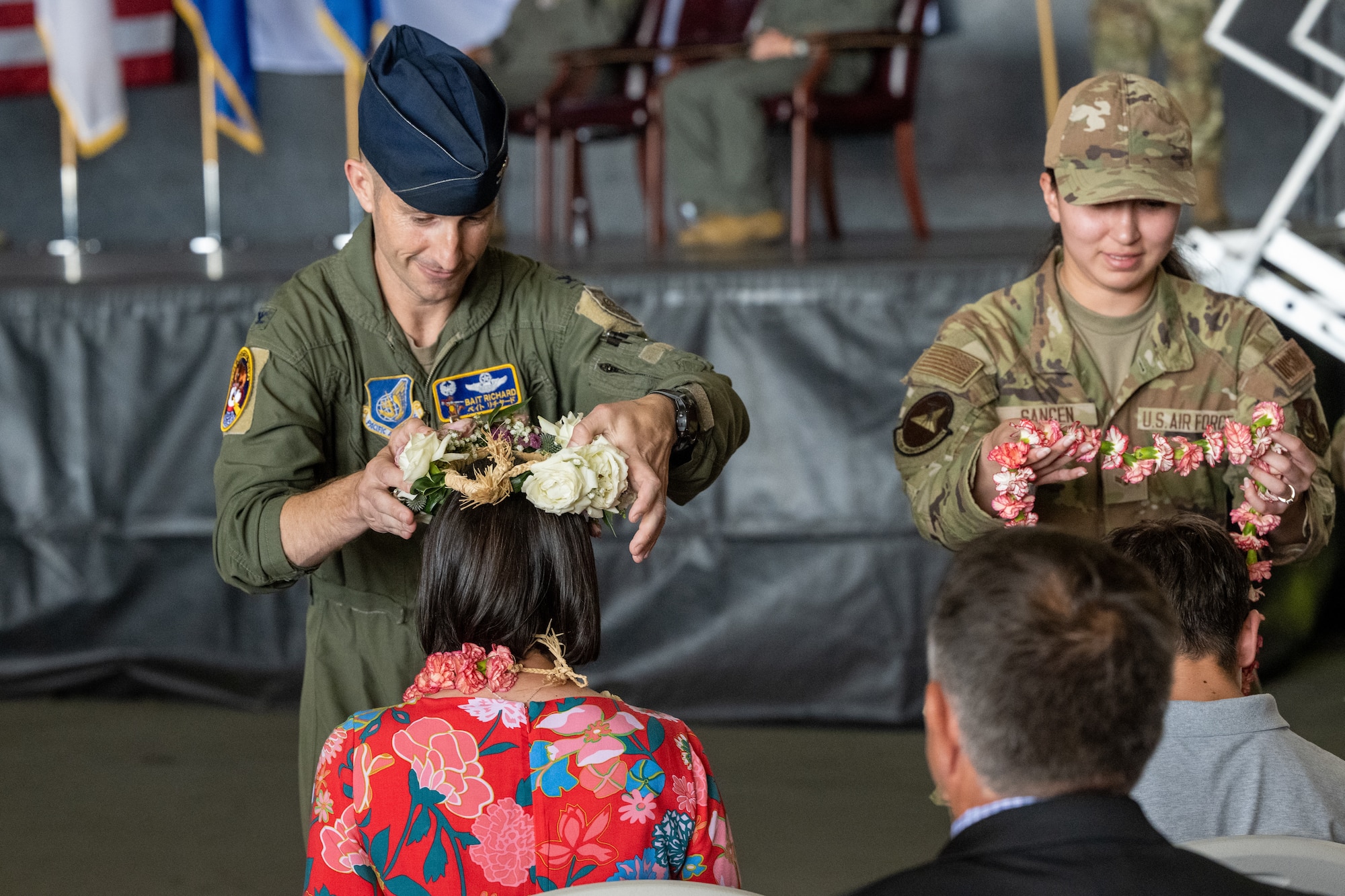 U.S. Air Force Col. Michael Richard, 35th Fighter Wing (FW) outgoing commander, gives his wife, Jessica, a  flower crown during the 35th FW change of command ceremony at Misawa Air Base, Japan, July 8, 2024.