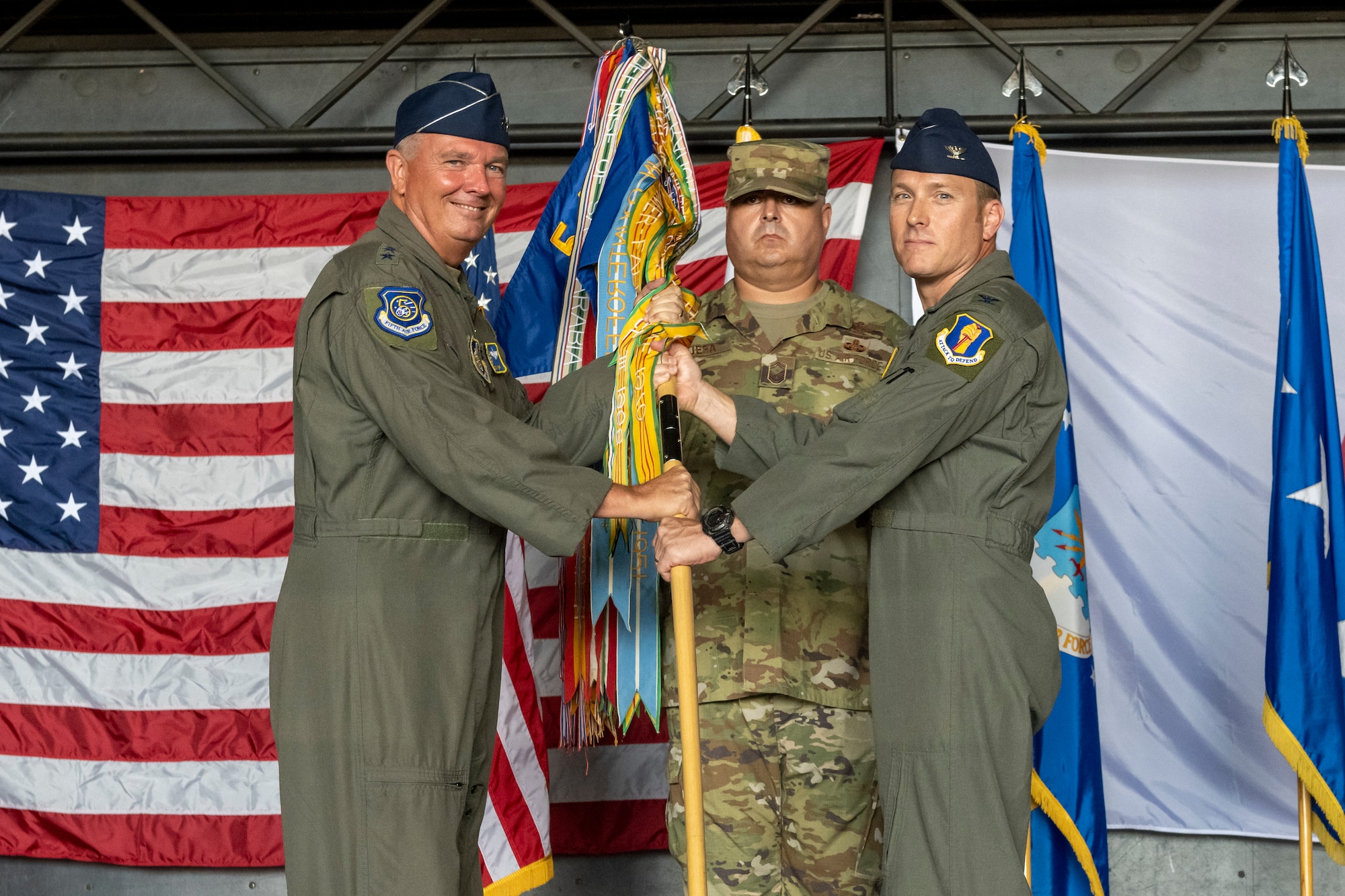 U.S. Air Force Lt. Gen. Ricky N. Rupp, left, U.S. Forces Japan and 5th Air Force commander, passes a guidon to Col. Paul Davidson, right, 35th Fighter Wing incoming commander, during the 35th FW change of command ceremony at Misawa Air Base, Japan, July 8, 2024.