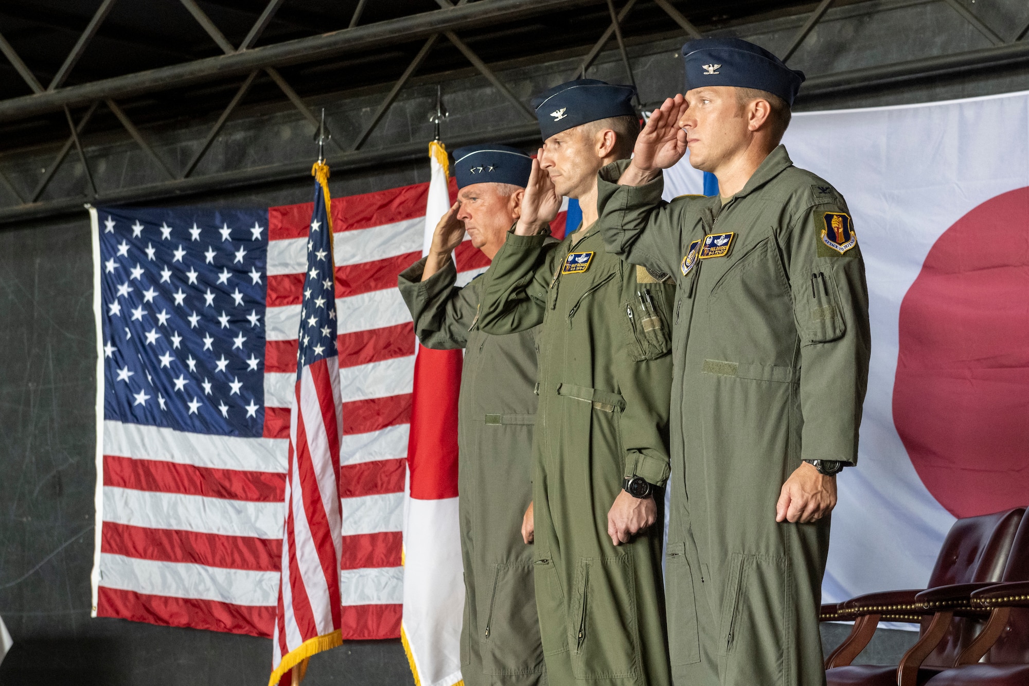 U.S. Air Force Col. Paul Davidson, right, 35th Fighter Wing incoming commander, Col. Michael Richard, middle, 35th FW outgoing commander, and Lt. Gen. Ricky Rupp, left, U.S. Forces Japan and 5th Air Force commander, render a salute for the national anthem during the 35th FW change of command ceremony at Misawa Air Base, Japan, July 8, 2024.