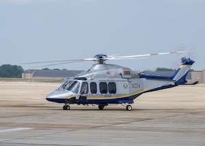 Helicopter sits on flightline.