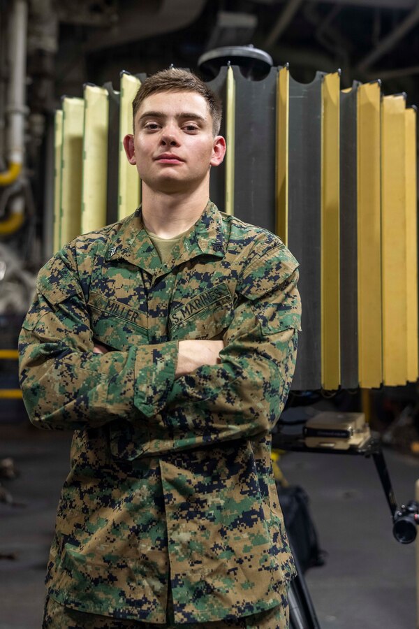 U.S. Marine Corps Cpl. Caleb Miller, a counter-battery radar team chief with 2nd Platoon, Romeo Battery, Battalion landing Team 1/8, 24th Marine Expeditionary Unit (MEU) Special Operations Capable (SOC), poses for a photo in front of a lightweight counter mortar radar aboard the amphibious assault ship USS Wasp (LHD 1) while underway in the Mediterranean Sea, July 2, 2024. The Wasp Amphibious Ready Group-24th MEU (SOC) is conducting operations in U.S. Naval Forces Europe area of operations to support high-end warfighting exercises while demonstrating speed and agility operating in a dynamic security environment. (U.S. Marine Corps photo by Lance Cpl. John Allen)