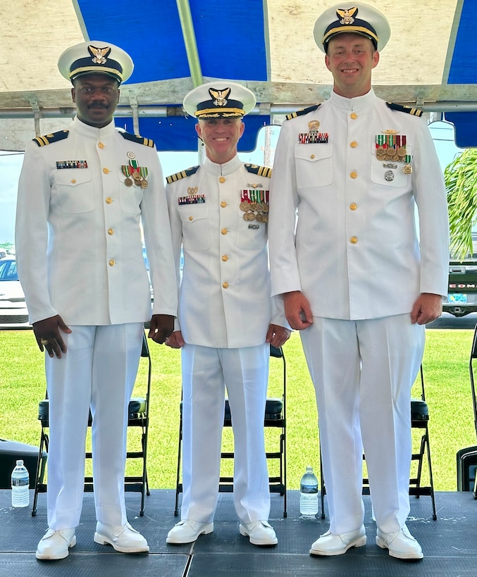 From left, U.S. Coast Guard Lt. Christopher Clark, Capt. Jason Ingram, and Lt. Bradford Long pose for a photo at the conclusion of a change of command ceremony for Sentinel-class fast response cutter USCGC William Trump (WPC 1111), July 3, 2024, in Key West, Florida.