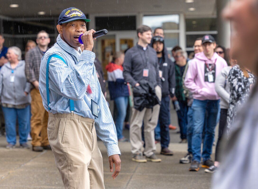 Eric Farmer, Human Resources assistant (Benefits), Commander Pacific Fleet Human Resources Office Northwest, performs as Rapper  E.J Trouble Enuff, for a talent show June 27, 2024, during Puget Sound Naval Shipyard & Intermediate Maintenance Facility's three-day "Pathway To Safety" training event, held June 26-28, in Bremerton, Washington. (U.S Navy Photo by Wendy Hallmark)