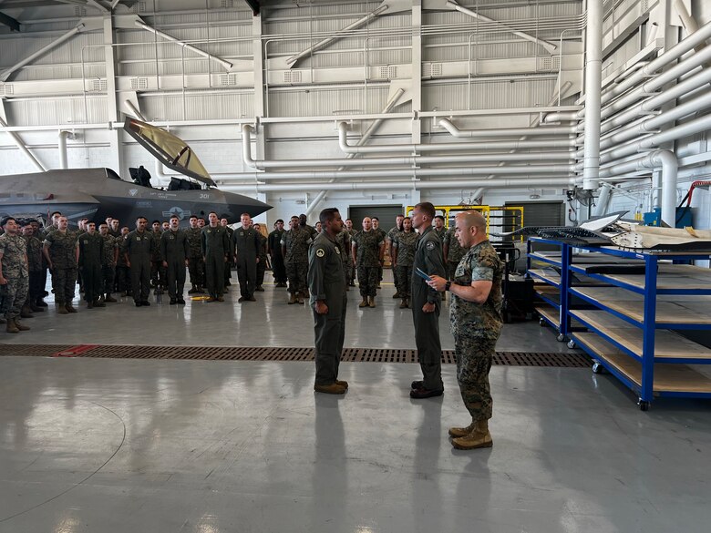 U.S. Marine Corps Gunnery Sgt. Christopher Goad, left, a powerline division chief with Marine Fighter Attack Squadron 314, Marine Aircraft Group 11, 3rd Marine Aircraft Wing, is awarded the Navy and Marine Corps Commendation Medal by Lt. Col. Jeffrey Davis, commanding officer of VMFA-314, at Marine Corps Air Station Miramar, California, July 1, 2024. Goad, president of the VMFA-314 motorcycle riding club, was awarded for providing life-saving aid to a fellow motorcycle rider on April 21, 2024. (U.S. Marine Corps courtesy photo)