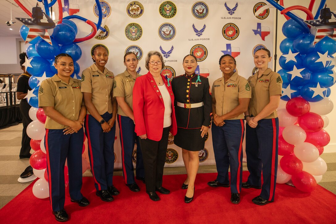 U.S. Marines with Recruiting Station Houston, 8th Marine Corps District, and Camilla Thomas, center, a Marine veteran, pose for a photo during the Texas Women Veteran's Day Ceremony at City Hall, Houston, Texas, June 12, 2024. The ceremony served to honor female veterans and recognize the history of women in the armed services - with the ceremony sharing the same date as the 76th anniversary of the Women's Armed Services Integration Act. (U.S. Marine Corps photo by Sgt. Ryan H. Pulliam)