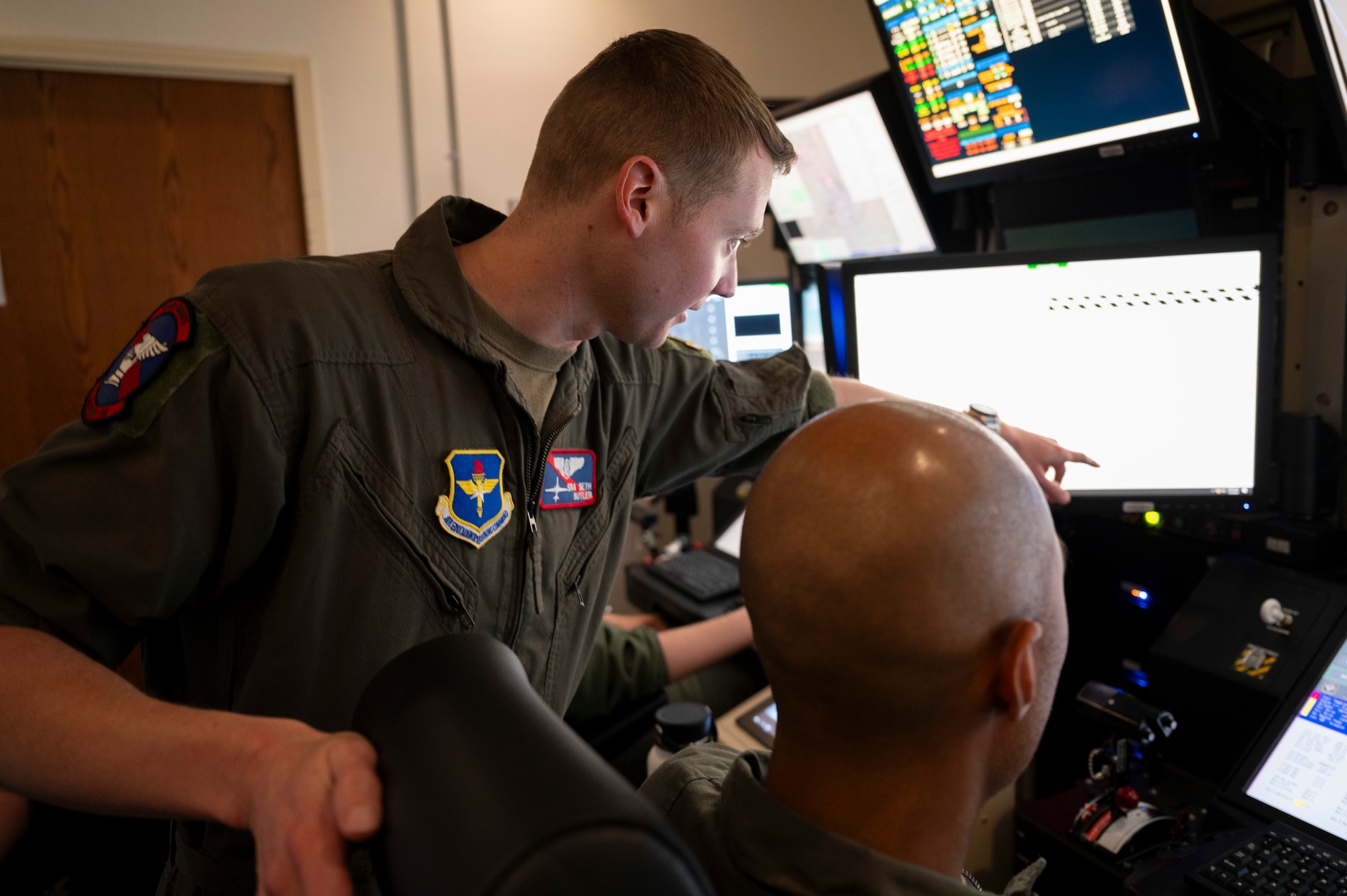 U.S. Air Force Senior Airman Seth Butler, 9th Attack Squadron MQ-9 Reaper sensor operator student instructor, oversees MQ-9 simulator training at Holloman Air Force Base, New Mexico, July 2, 2024.