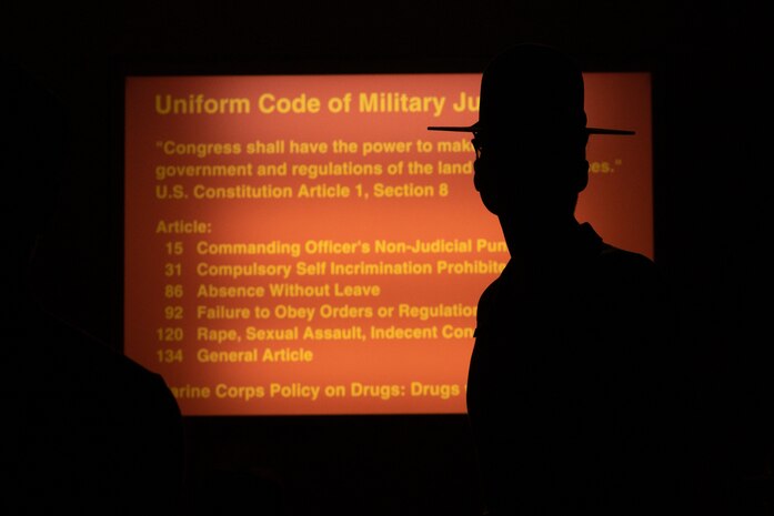 U.S. Marine Corps Sgt. Natali Moreno, a drill instructor with Receiving Company, Support Training Battalion, briefs recruits with Fox Company, 2nd Recruit Training Battalion, on the Uniform Code of Military Justice as part of a receiving event at Marine Corps Recruit Depot San Diego, California June 24, 2024. During the receiving process recruits are checked for contraband, given haircuts, make a scripted phone call home, and are issued their gear required for training. (U.S. Marine Corps photo by Lance Cpl. Janell B. Alvarez)