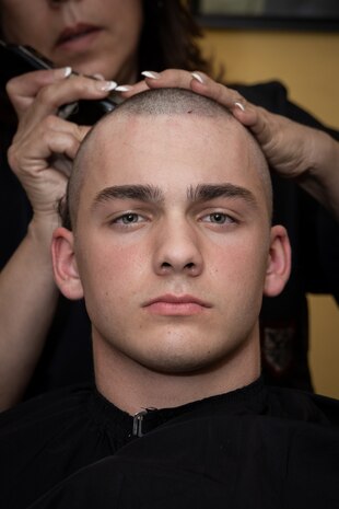 U.S. Marine Corps Recruit Dylan Mason with Fox Company, 2nd Recruit Training Battalion, receives a haircut as part of the receiving process at Marine Corps Recruit Depot San Diego, California, June 24, 2024. During the receiving process recruits are checked for contraband, given haircuts, make a scripted phone call home, and are issued their gear required for training. (U.S. Marine Corps photo by Lance Cpl. Janell B. Alvarez)