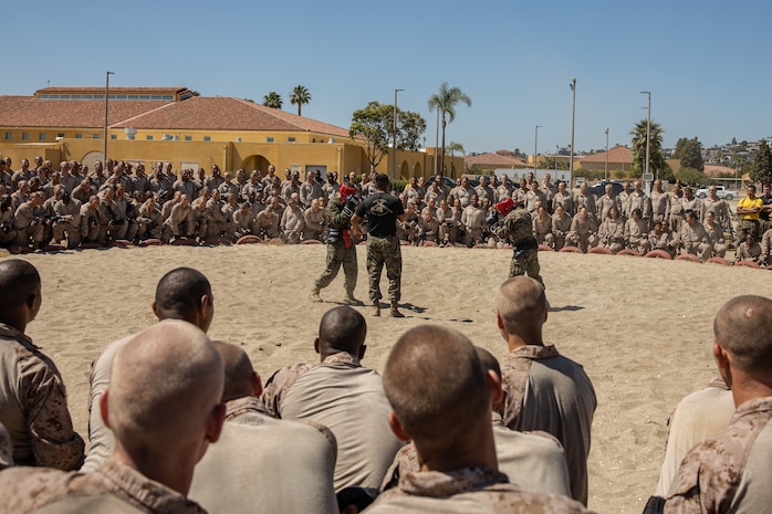 U.S. Marine Corps Martial Arts Instructor, Sgt. Edward Baltazar, with Support Battalion, Recruit Training Regiment, briefs recruits with Golf Company, 2nd Recruit Training Battalion, on a body sparring demonstration at Marine Corps Recruit Depot San Diego, California, July 1, 2024. Recruits are taught Marine Corps Martial Arts Program techniques that instill basic self-defense that they will execute throughout recruit training during events like body sparring and pugil sticks to help build a warrior ethos and esprit de corps. (U.S. Marine Corps photo by Cpl. Sarah M. Grawcock)