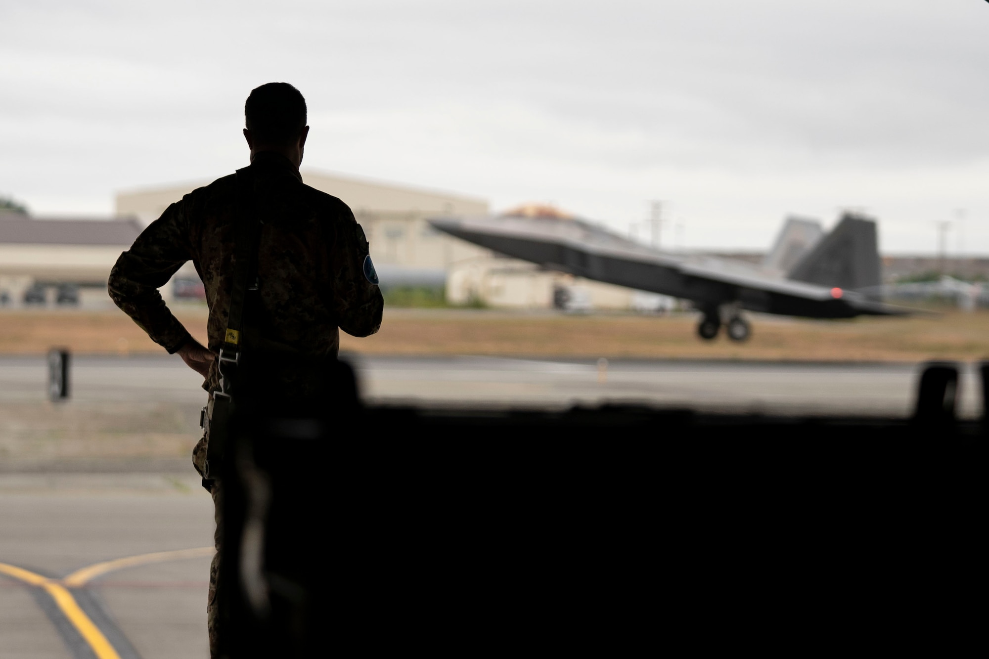 An Italian Air Force officer watching an F-22 Raptor launch