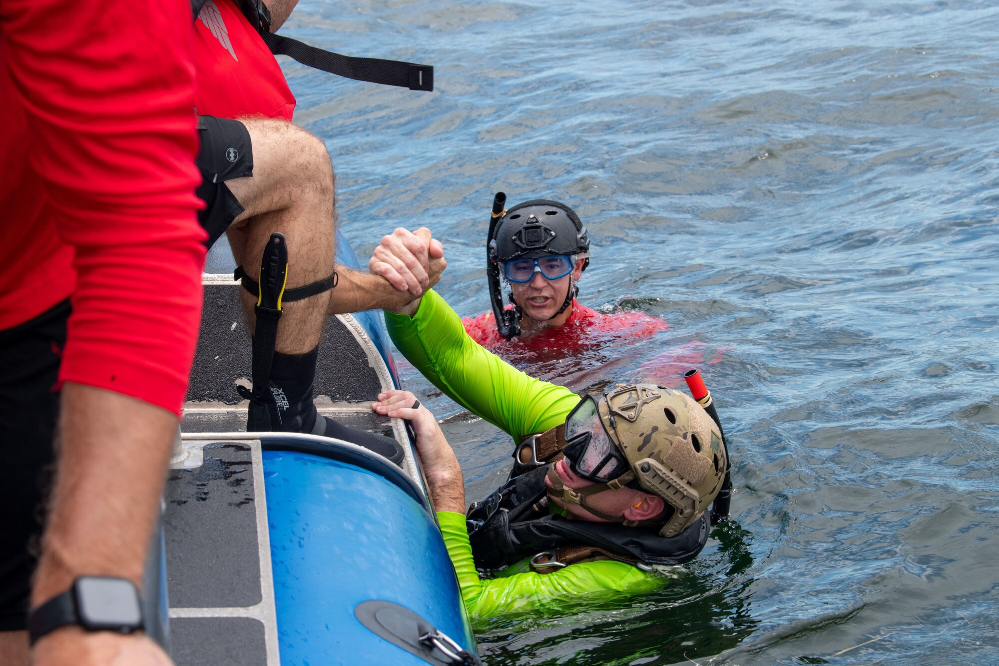U.S. Air Force Chief Master Sgt. Justin Geers, 23rd Wing command chief, climbs onto anAir Force maritime vessel from the 38th Rescue Squadron, after jumping tandem with a pararescueman assigned to the 38th RQS during a battlefield circulation in the Gulf of Mexico, June 24, 2024. Pararescuemen undergo intensive training including the Special Warfare Preparatory Course, Combat Dive Course, Airborne School and Military Free-Fall Course. PJs are also certified paramedics with training in special tactics, emergency medicine, weapons, combat, mountaineering and more. (U.S. Air Force photo by 2nd Lt. Benjamin Williams)