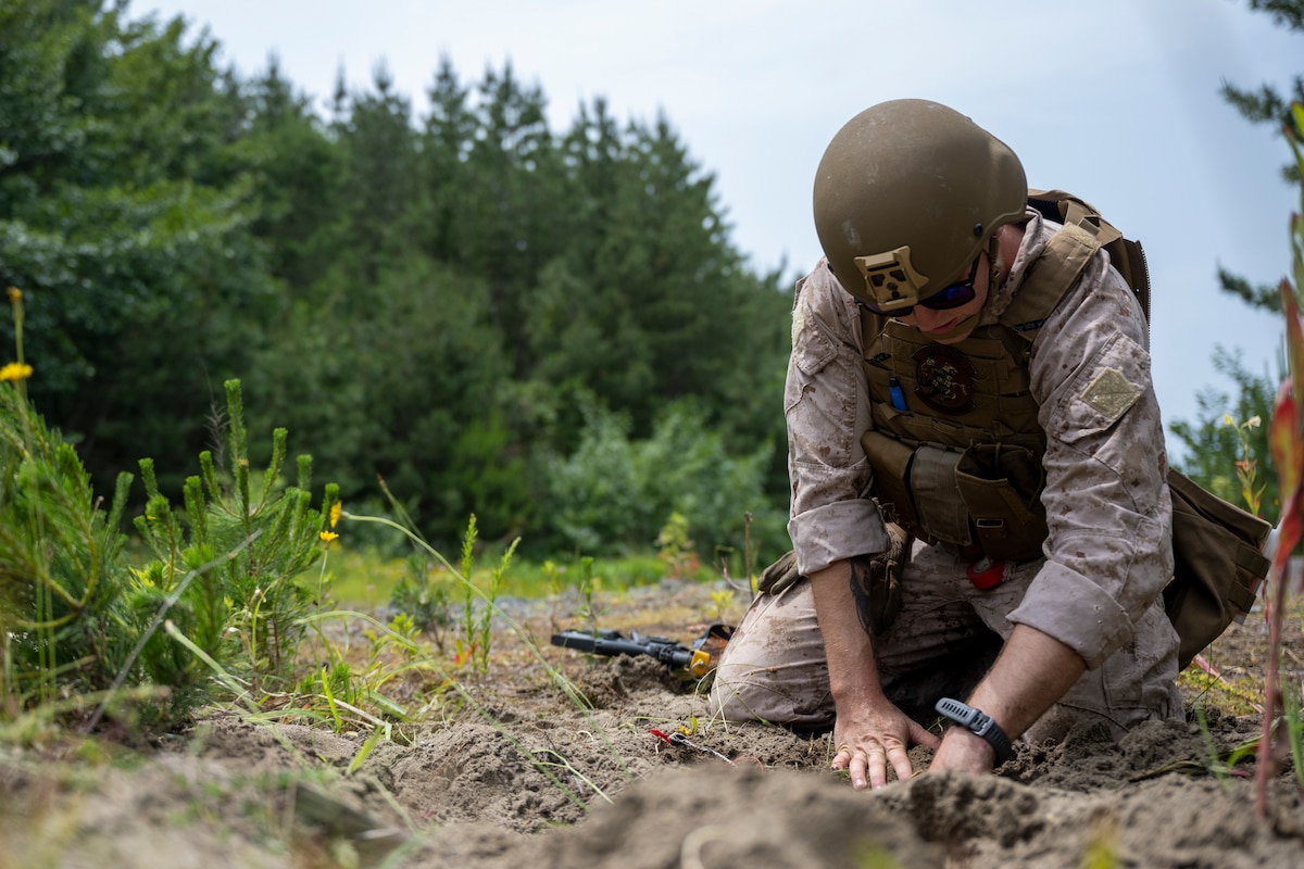 A U.S. Marine Corps explosive ordnance disposal technician works on disarming a simulated explosive trap during Exercise Tanuki Bandit 24 at Draughn Range near Misawa Air Base, Japan, June 25, 2024.