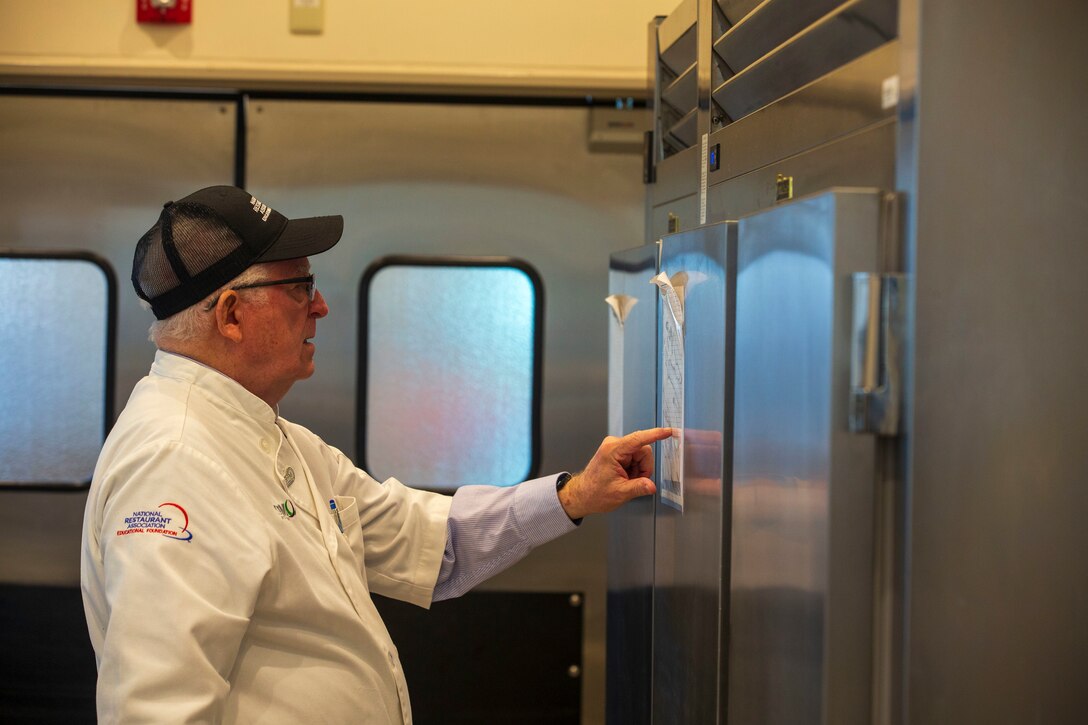 Mike Johnston, a member of the National Restaurant Association Education Foundation, inspects the equipment of the Flight Line Mess Hall at Marine Corps Air Station Iwakuni, Japan, as part of the Maj. Gen. William Pendleton Thompson (W.P.T.) Hill memorial awards program, Jan. 29, 2024. The W.P.T. Hill awards program aims to acknowledge outstanding performance within Marine Corps food service operations, including determining and recognizing the best mess halls of the year.