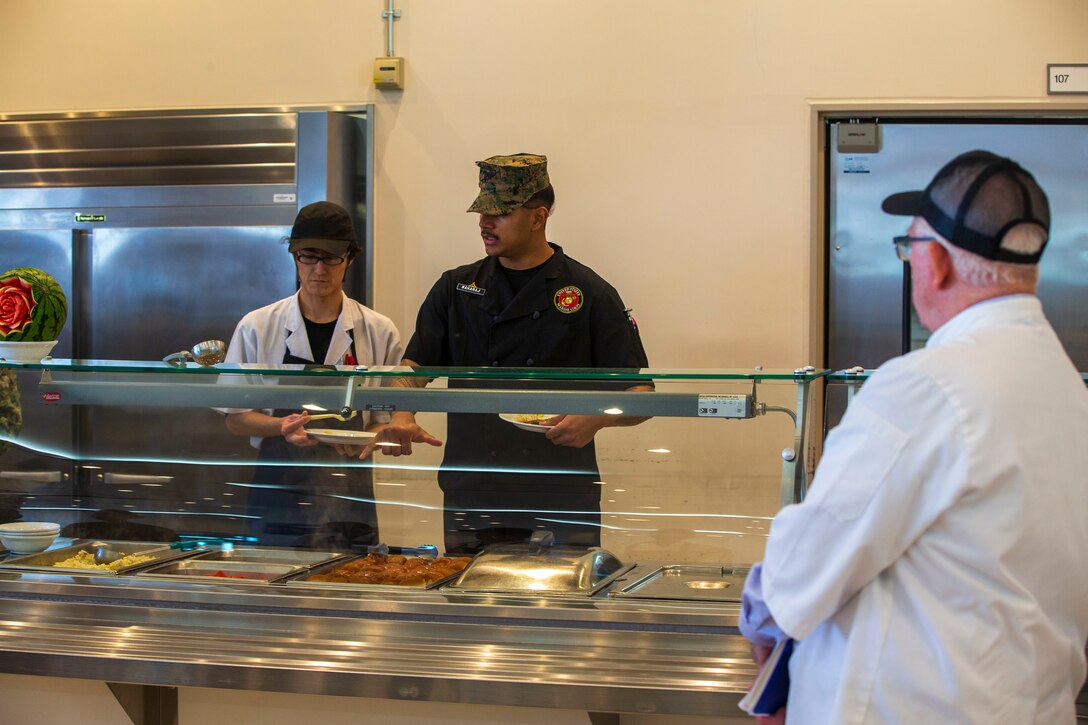 Mike Johnston, a member of the National Restaurant Association Education Foundation, observes meal preparations before food is served at the Flight Line Mess Hall at Marine Corps Air Station Iwakuni, Japan, as part of the Maj. Gen. William Pendleton Thompson (W.P.T.) Hill memorial awards program, Jan. 29, 2024. The W.P.T. Hill awards program aims to acknowledge outstanding performance within Marine Corps food service operations, including determining and recognizing the best mess halls of the year.