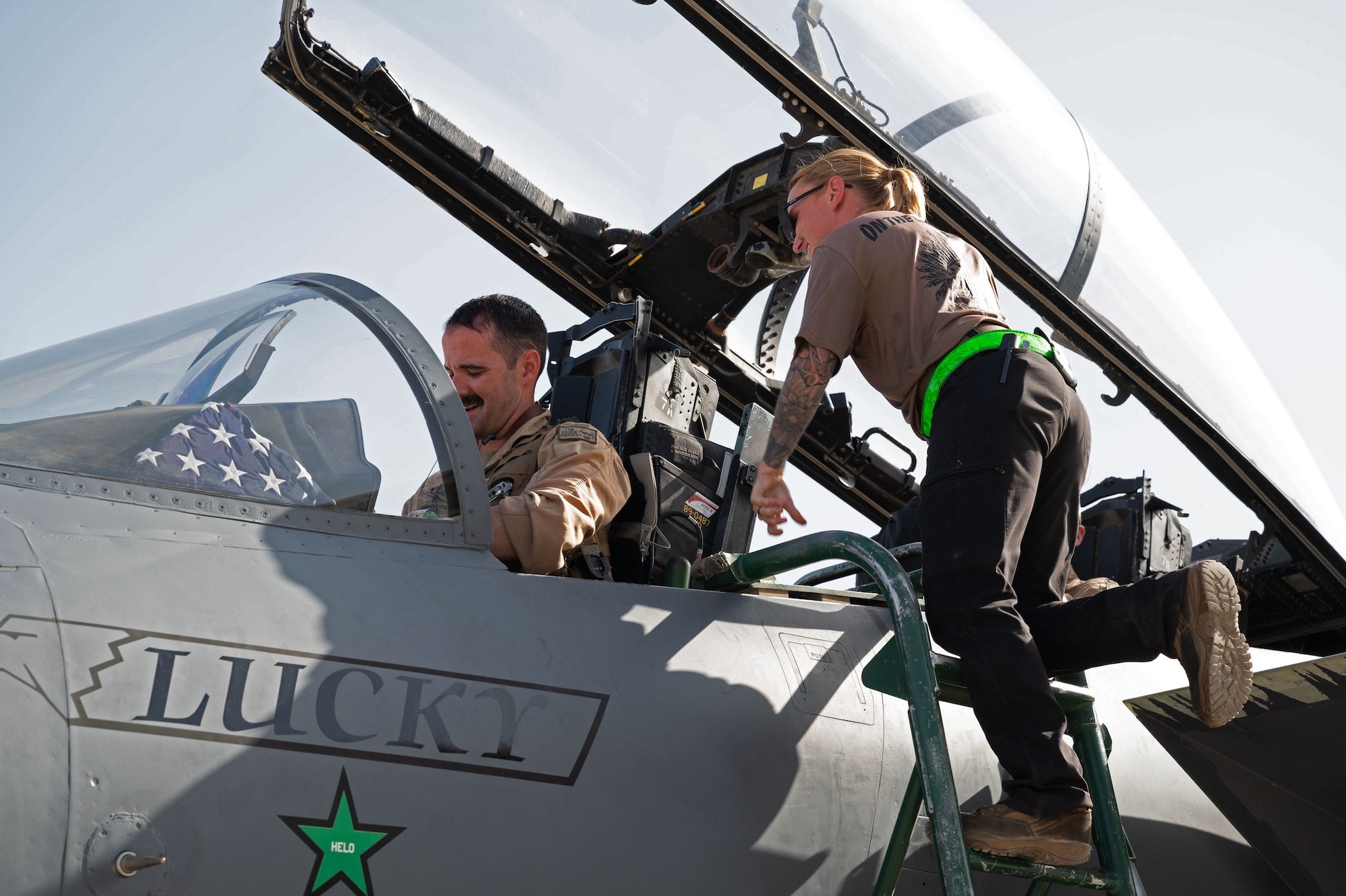 A U.S. Air Force 335th Expeditionary Fighter Generation Squadron crew chief assists an F-15E Strike Eagle pilot, at an undisclosed location in the U.S. Central Command area of responsibility, May 17, 2024. The Strike Eagle was designed in the 1980s for long-range, high-speed interdiction without relying on an escort or electronic-warfare aircraft. (U.S. Air Force photo)