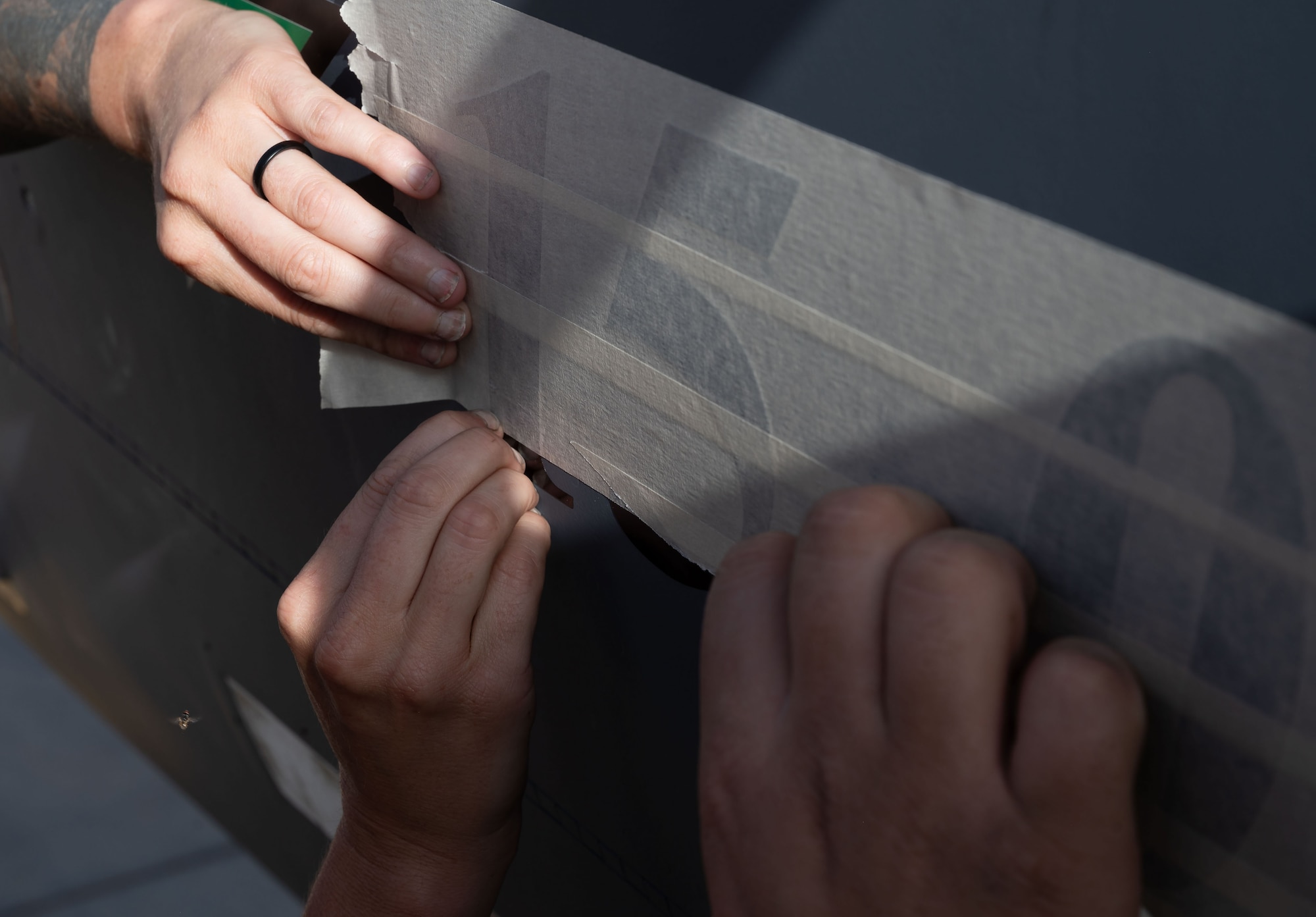 A U.S. Air Force 335th Expeditionary Fighter Generation Squadron crew chief places a “15,000” sticker on an F-15E Strike Eagle, at an undisclosed location in the U.S. Central Command area of responsibility, May 17, 2024. The dual-role fighter achieved a major milestone for a fighter aircraft with 15,000 flights hours, which equates to 624 days flying since its production in 1989. (U.S. Air Force photo)