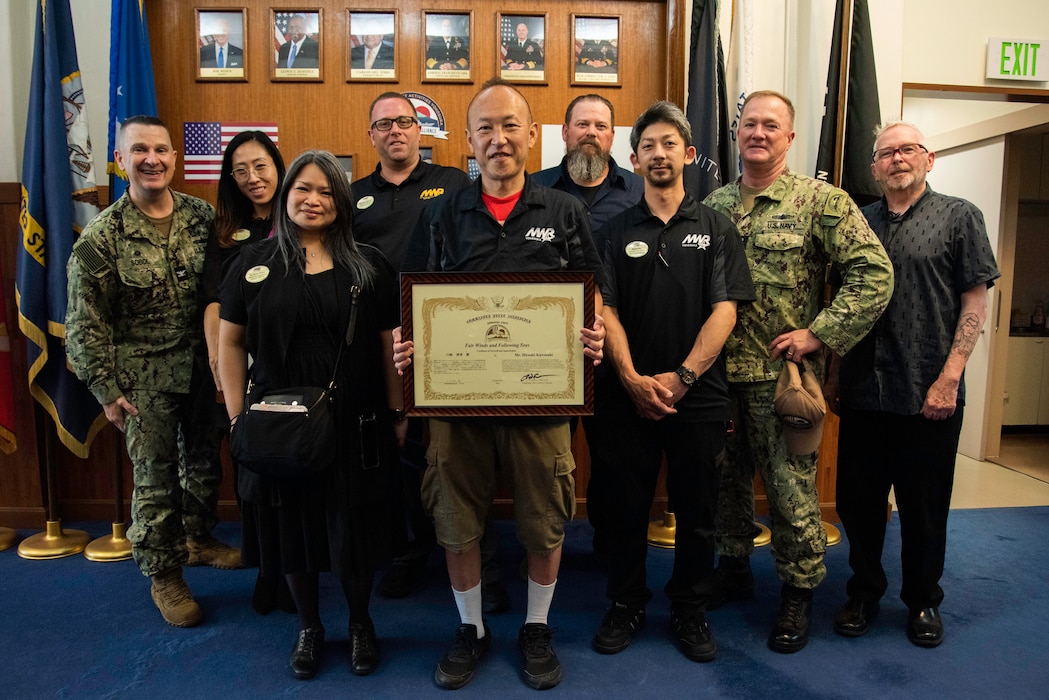 Hiroaki Kawasaki, a facilities custodian at MWR Yokosuka, receives a Certificate of Farewell and Appreciation for his dedication and support to the U.S. Navy at Commander, Fleet Activities Yokosuka from April 1998 through June 2024.