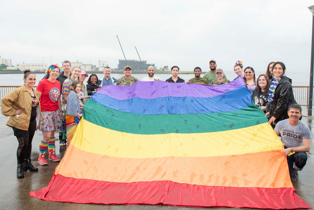 Capt. Les Sobol, Commander, Fleet Activities Yokosuka (CFAY), and members of the CFAY community pose for a photo during the 2024 Pride Month Observance Ceremony at CFAY’s Berkey Field.