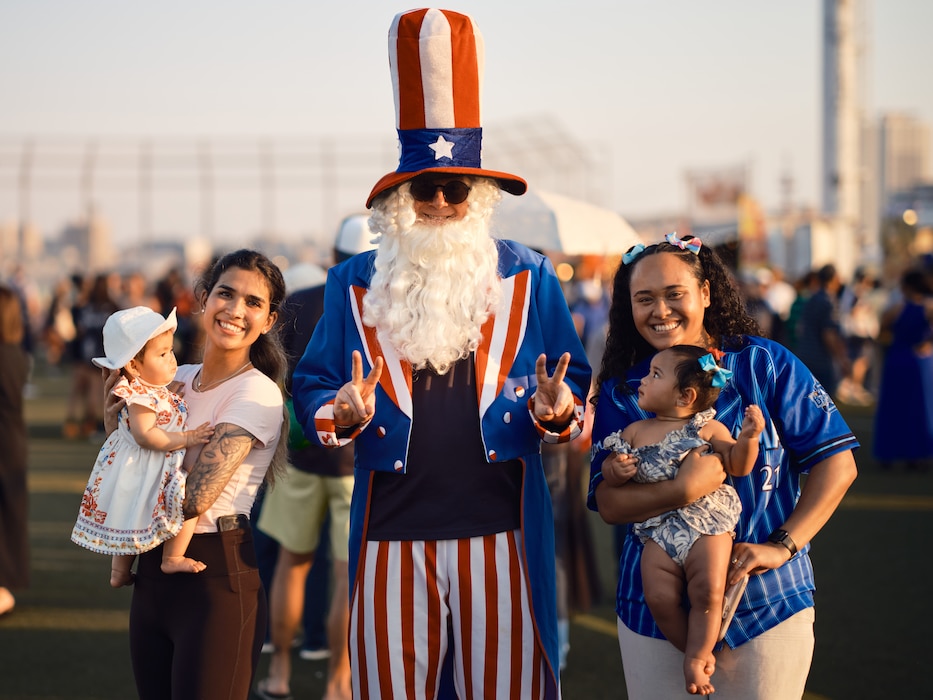 Base community members pose with Uncle Sam at the 4th of July Celebration at Commander, Fleet Activities Yokosuka July 4, 2024.