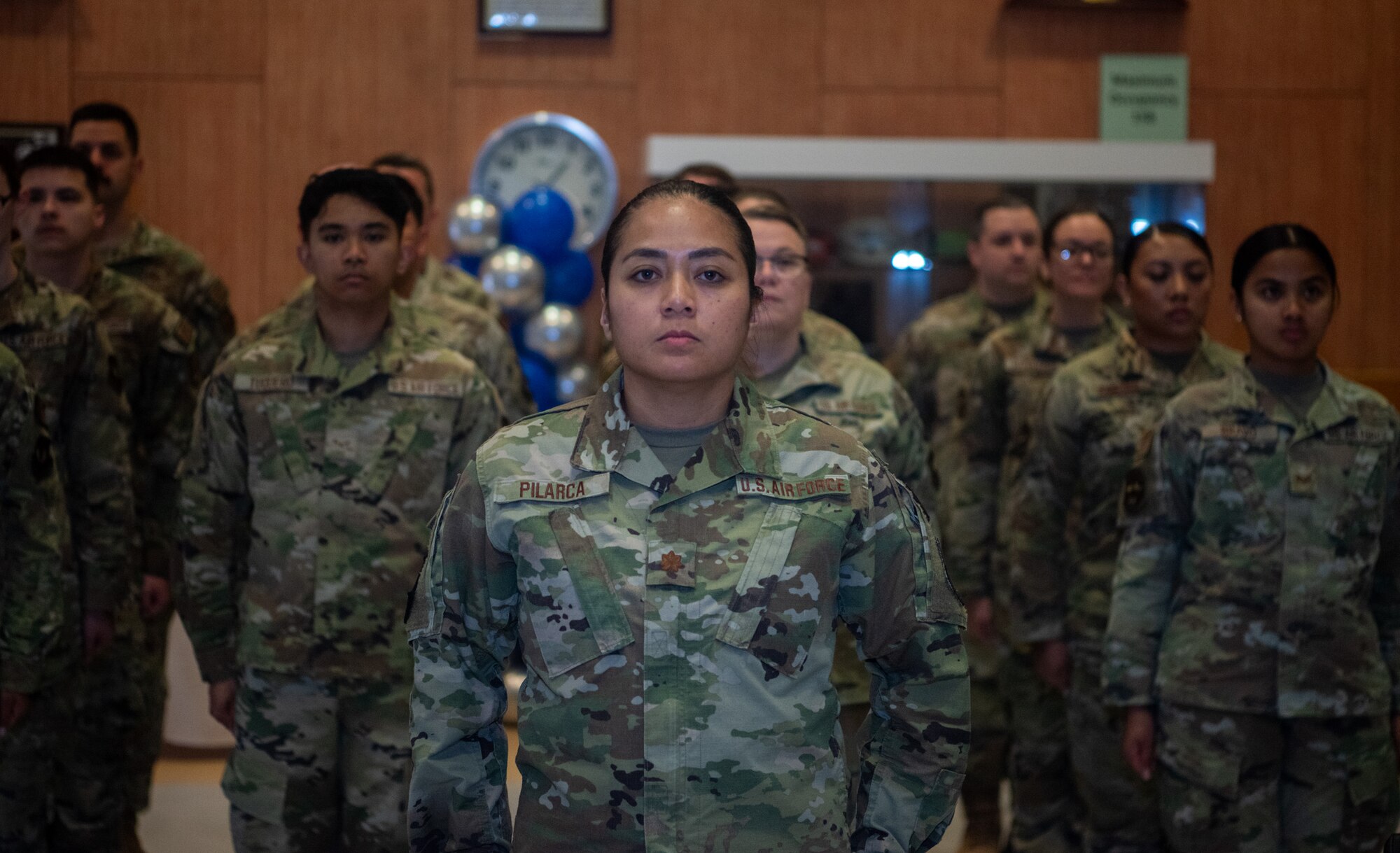 Airmen stand in formation.