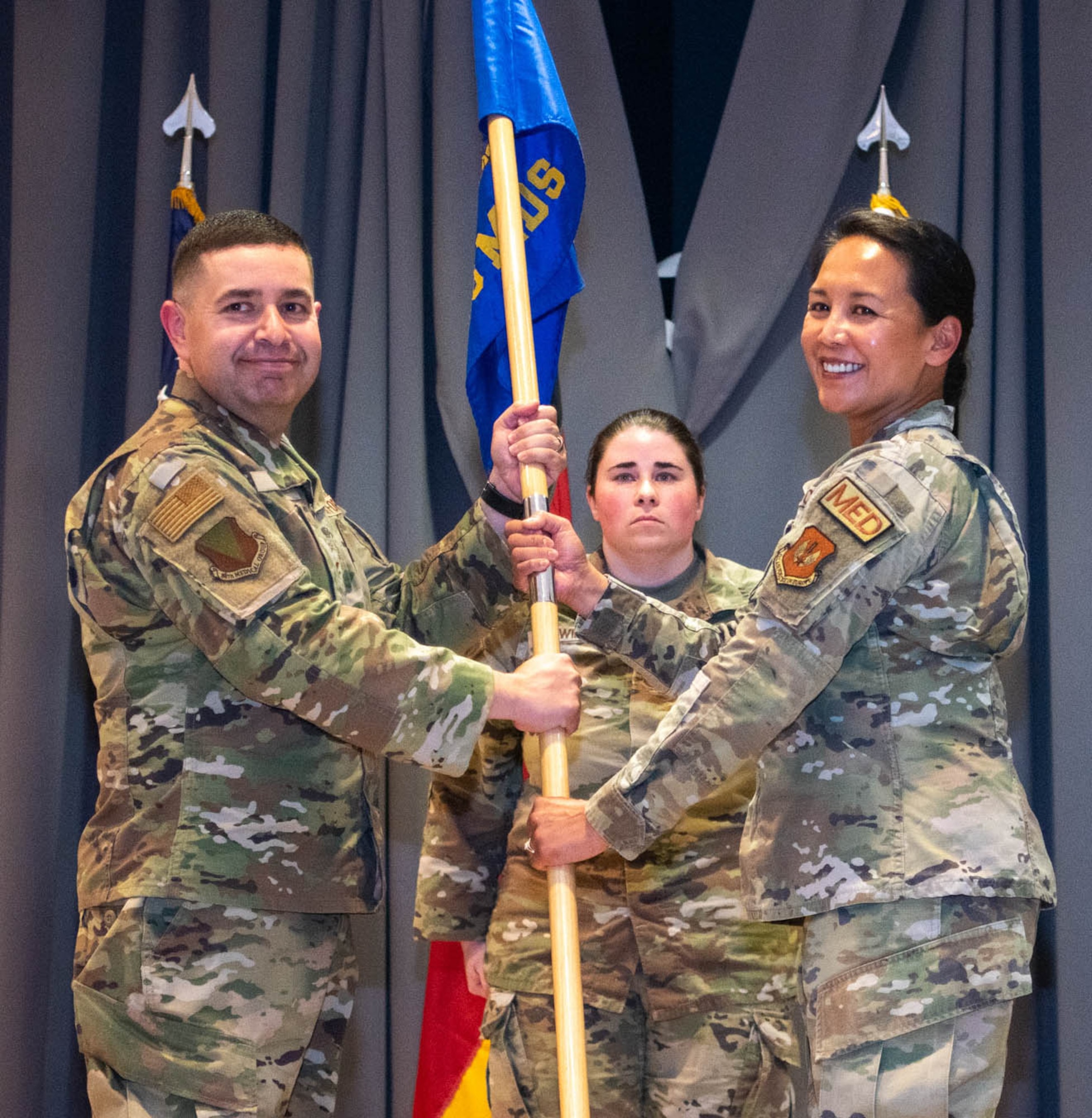 Group commander receives guidon from outgoing squadron commander.