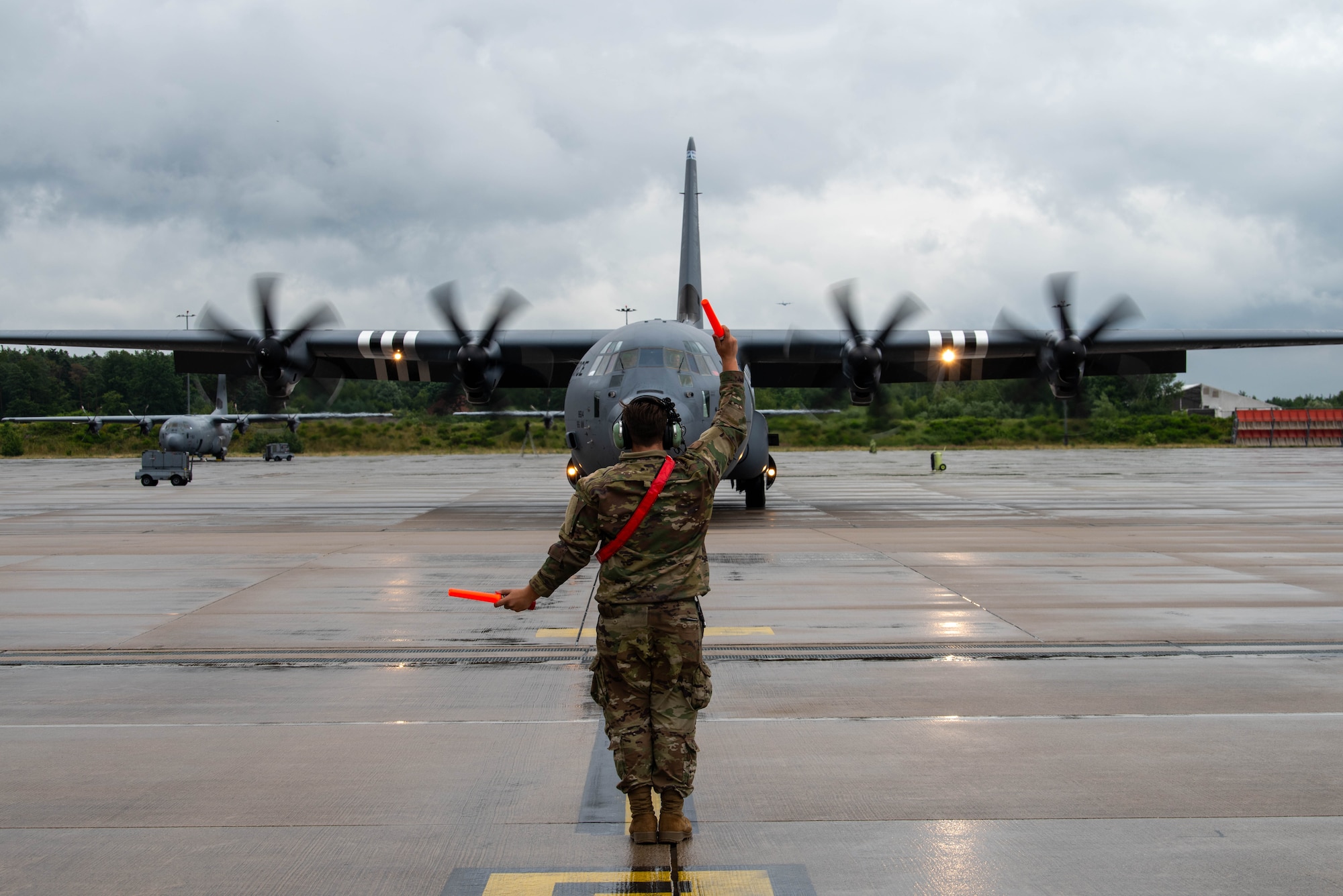 Airman marshals aircraft.
