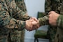 U.S. Army Maj. Gen. John H. Phillips, the U.S. European Command's Command, Control, Communications, Computers and Cyber Director (J-6) gives a coin to a U.S. Marine with 8th Communications Battalion, II Marine Expeditionary Force (MEF) Information Group at Bardufoss, Norway, Feb. 27, 2024. The J-6 is a joint staff section responsible for command, control, communications and computer systems and provides commanders with the ability to make and communicate timely decisions across their areas of operations. II MEF Marines are participating in exercise Nordic Response 24 which is a Norwegian national readiness and defense exercise designed to enhance military capabilities and allied cooperation. This exercise will test military activities ranging from the reception of allied and partner reinforcements and command and control interoperability to combined joint operations, maritime prepositioning force logistics, integration under challenging Arctic conditions, in high-intensity warfighting including rugged terrain and extreme cold weather with NATO militaries, and reacting against an adversary force during a dynamic training environment. (U.S. Marine Corps photo by Cpl. Jacquilyn Davis)