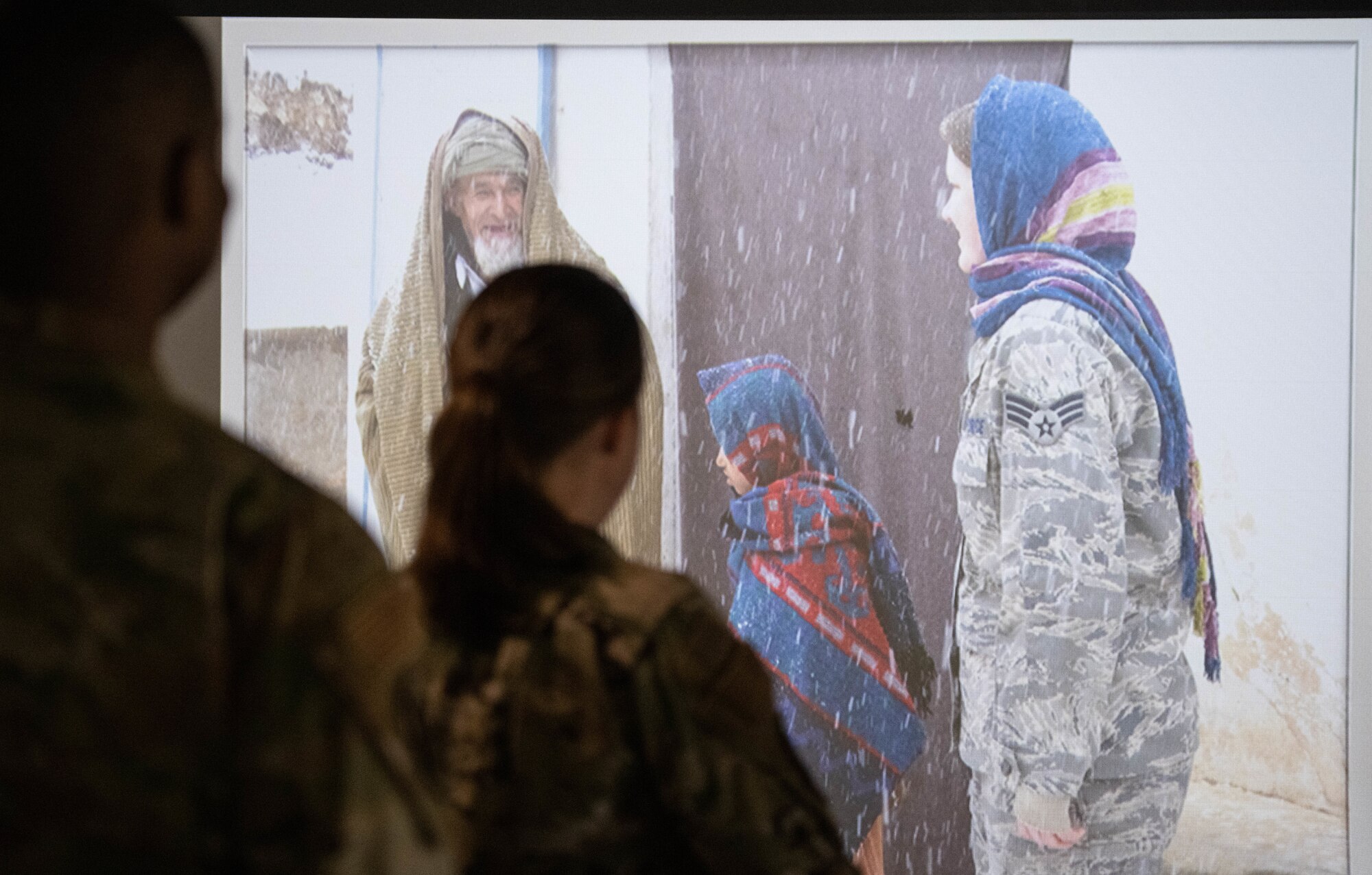 U.S. Airmen watch slideshow.