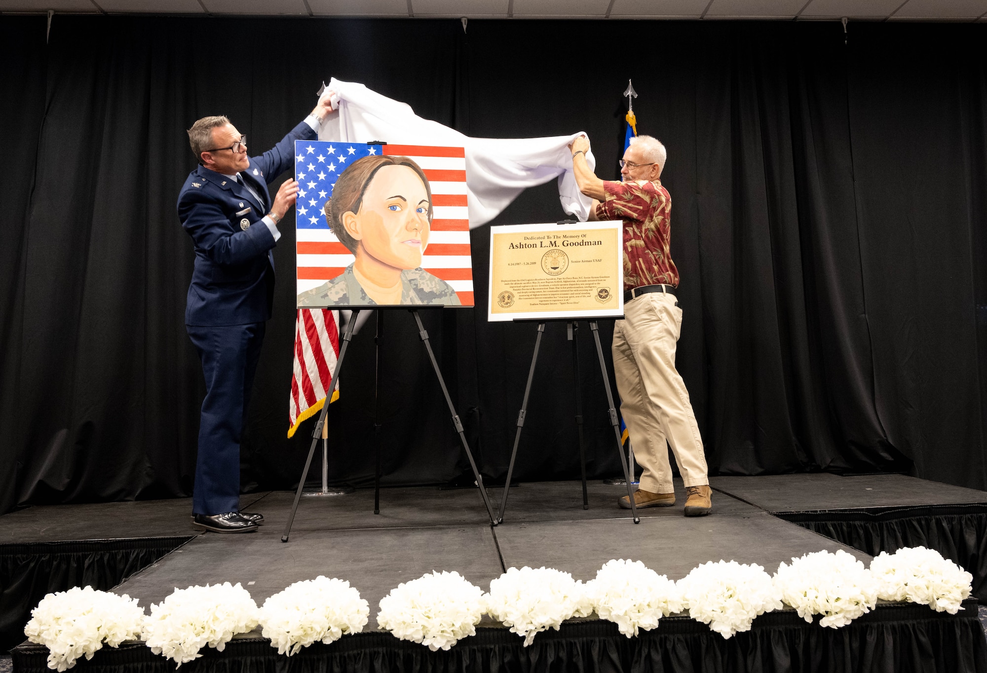U.S. Air Force colonel and family member of deceased Airman unveil portrait.