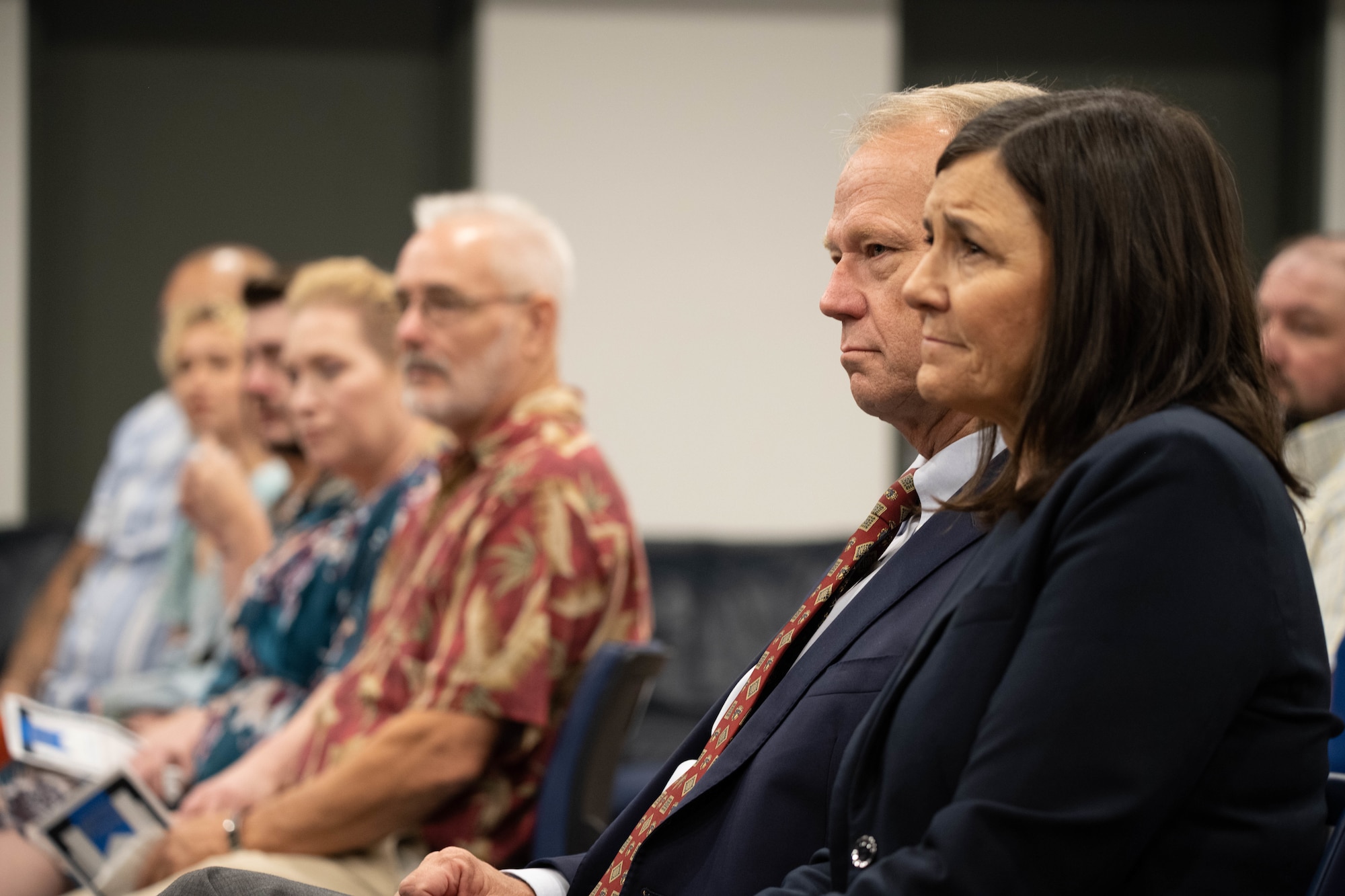 Previous coworker of deceased U.S. Airman listens to remarks.