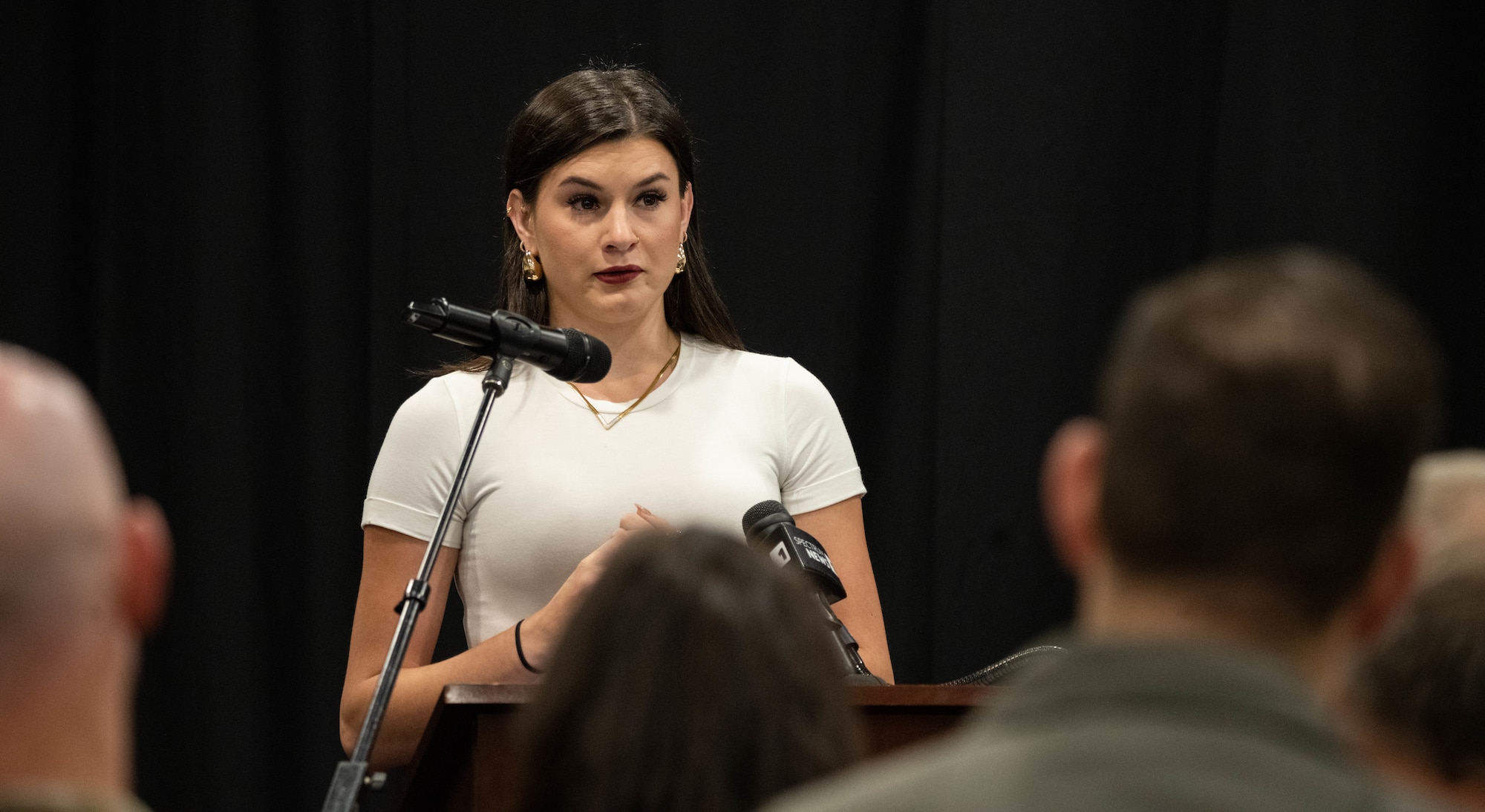 Sister of deceased U.S. Airman speaks during event.