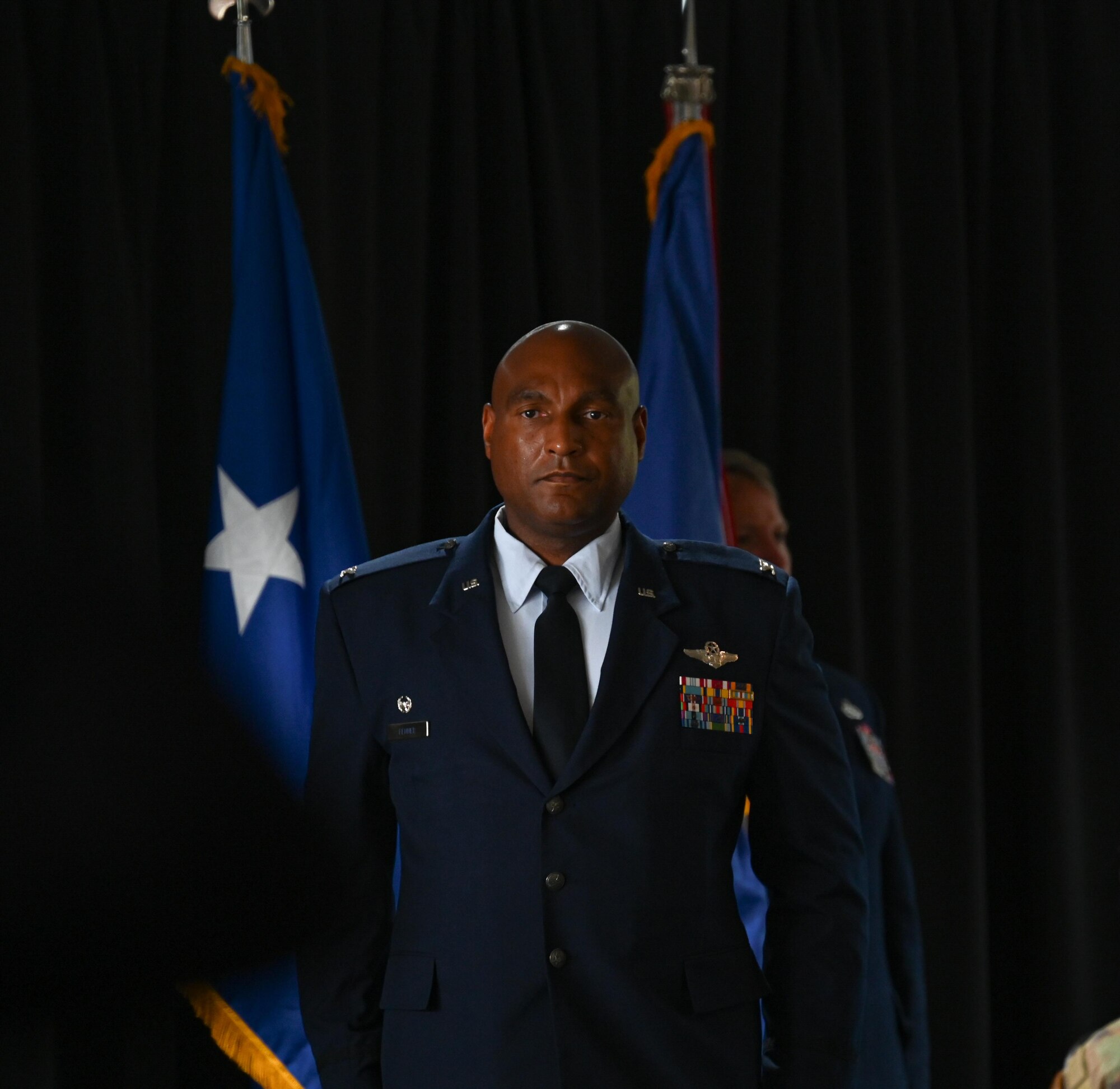U.S. Air Force Col. Larry Fenner Jr., 350th Spectrum Warfare Wing commander, stands at attention after rendering his first salute to the wing after taking command at Eglin Air Force Base, Florida, July 9, 2024. Fenner is the wing’s third commander and previously served as the deputy wing commander for the 36th Wing at Anderson AFB, Guam. (U.S. Air Force photo by Capt. Benjamin Aronson)