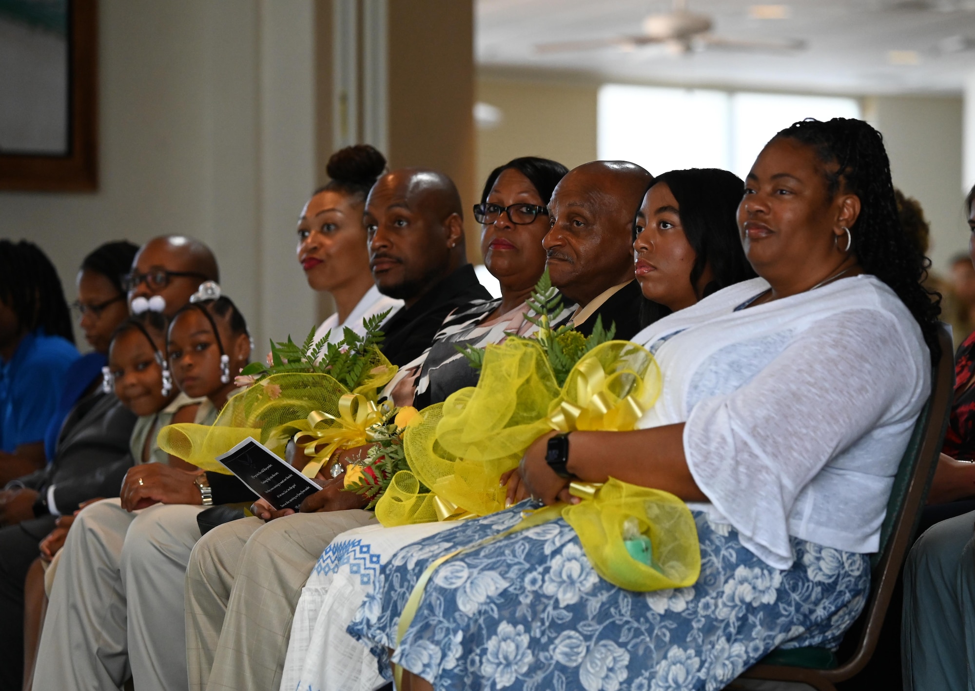 The family of U.S. Air Force Col. Larry Fenner Jr., 350th Spectrum Warfare Wing commander, watch as Fenner gives his first remarks as wing commander at his change of command ceremony, Eglin Air Force Base, Florida, July 9, 2024. Fenner is an electronic warfare officer with service in the B-52 and served the United States Indo-Pacific Command as Command Electronic Warfare Officer and Air Force Global Strike Command as Chief of Bomber Requirements. (U.S. Air Force photo by Capt. Benjamin Aronson)