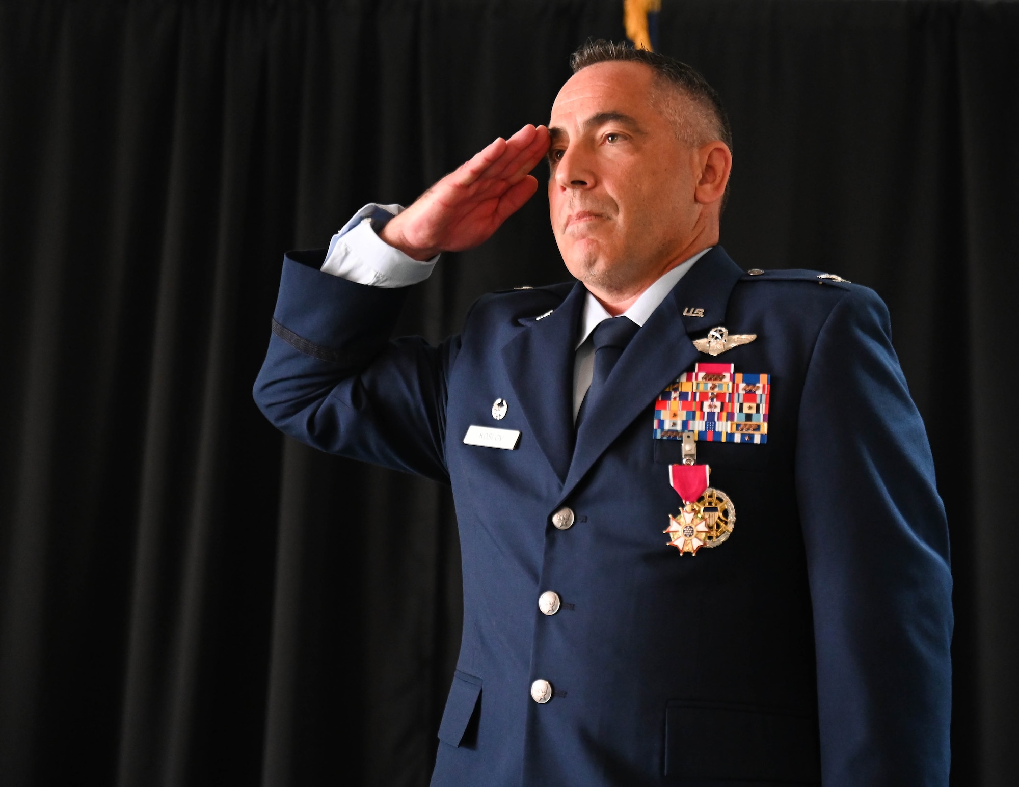 U.S. Air Force Col. Josh Koslov, 350th Spectrum Warfare Wing outgoing commander, salutes after receiving the Legion of Merit Medal for his service as wing commander at Eglin Air Force Base, Florida, July 9, 2024. Koslov oversaw the stand up of five units at the wing, including the historic 388th Electronic Warfare Squadron and 563d EWS, along with the initial detachments that are projected to become the future 950th Spectrum Warfare Group at Robins AFB, GA, focusing on the assessment of Air Force Electromagnetic Warfare capabilities to ensure the readiness of the Combat Air Force. (U.S. Air Force photo by Senior Airman Anna Smith)