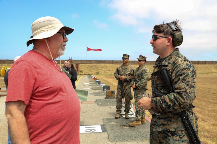 Garland Ganter, left, a Houston, Texas-area educator, speaks to U.S. Marine Corps Cpl. Charles Moser III, a combat marksmanship coach with Weapons and Field Training Battalion, Marine Corps Recruit Depot San Diego, during Educator's Workshop at Marine Corps Base Camp Pendleton, Calif., May 29, 2023. Educator's Workshop is a four-day program, held annually, designed to inform high school and college educators about the commitment and benefits of service in the U.S. Marine Corps. Attendees then return to their place of business with the ability to provide firsthand experience and knowledge to individuals interested in military service. (U.S. Marine Corps photo by Sgt. Ryan H. Pulliam)