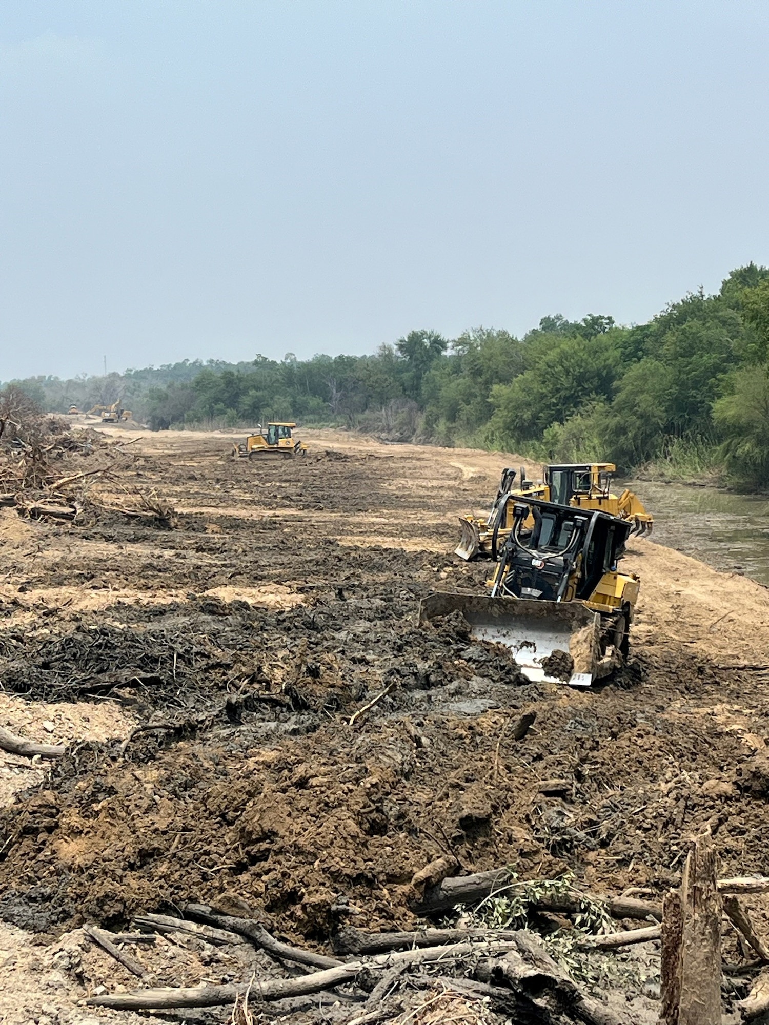U.S. Airmen assigned to the 202nd RED HORSE Squadron construct a water outlet spanning approximately 1.5 miles on Fronton Island, Texas, in support of Operation Lone Star, April 29 - May 31. Their goal was to aid Texas in reducing illegal drug and immigration trafficking by restricting the movement of known cartel groups in one of the most contested and dangerous areas on the U.S.-Mexico border. (Courtesy photo) (This image was edited to exclude a member's name due to operational security considerations.)
