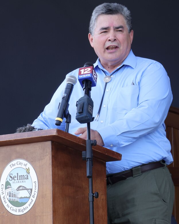 Man speaking at a podium.