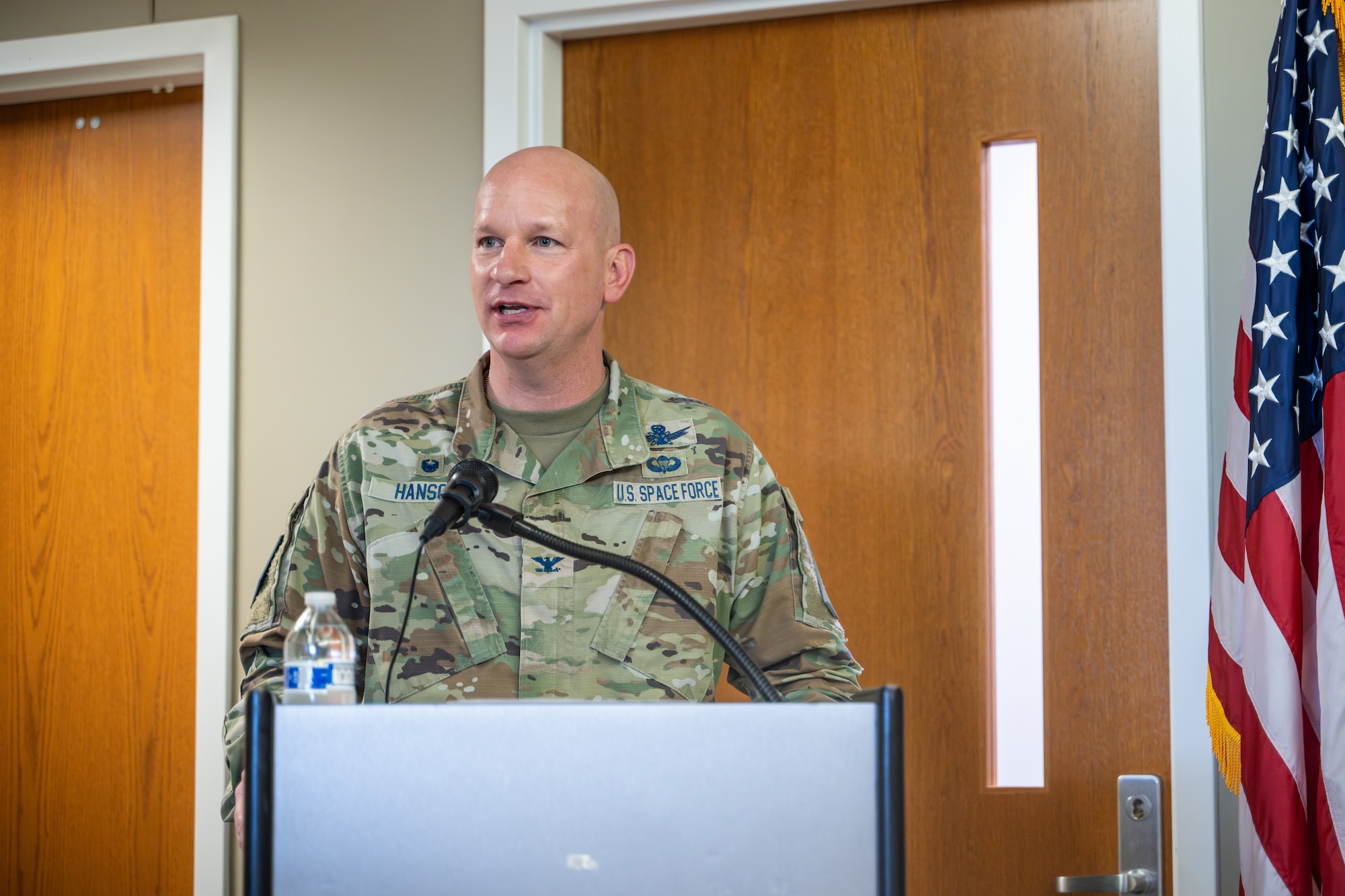 U.S. Space Force Col. David Hanson, Space Base Delta 1 commander, addresses the audience during an opening ceremony of the new medical clinic on Schriever Space Force Base, Colorado, July 1, 2024. Military bases must have medical facilities to ensure the health and well-being of their personnel and families. With a growing base, these improvements are geared toward increasing operational readiness and overall quality of life for the community at Schriever SFB. (U.S. Space Force photo by Dalton Prejeant)