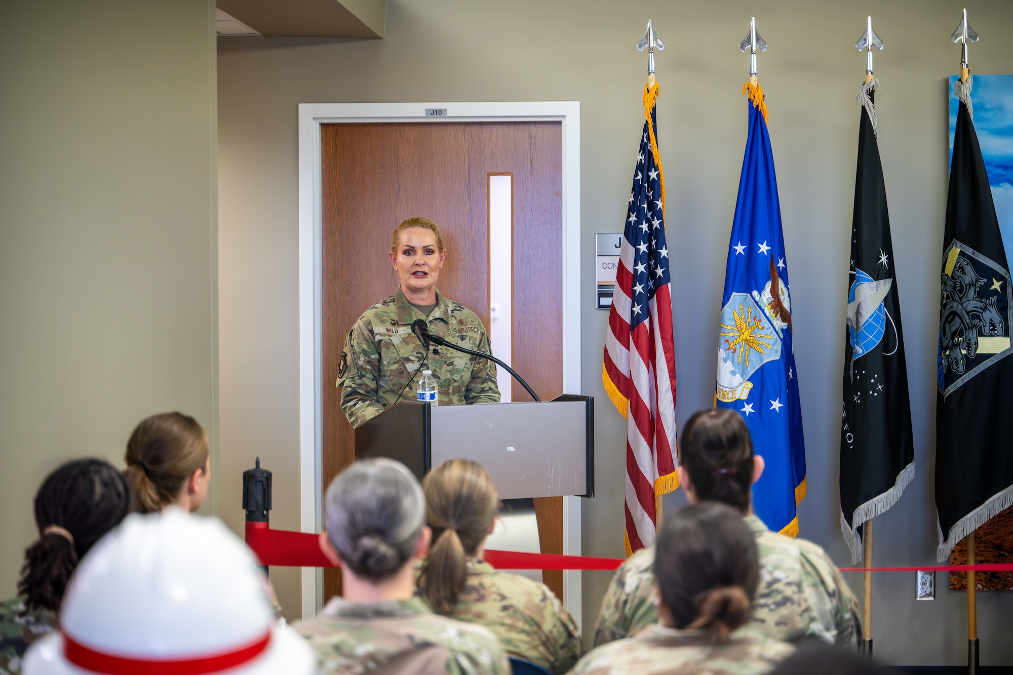 U.S. Air Force Lt. Col. Elaina Wild, 21st Medical Squadron commander, addresses the audience during an opening ceremony of the new medical clinic at Schriever Space Force Base, Colorado, July 1, 2024. Military bases must have medical facilities to ensure the health and well-being of their personnel and families. With a growing base, these improvements are geared toward increasing operational readiness and overall quality of life for the community at Schriever SFB. (U.S. Space Force photo by Dalton Prejeant)