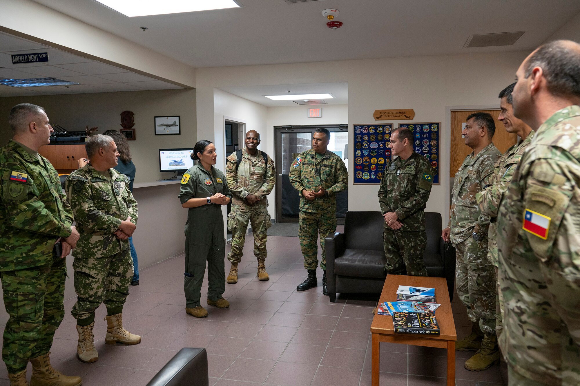 Lt. Col. Maria Methe, commander of the 45th Reconnaissance Squadron at Offutt AFB, Neb., briefs seven foreign liaison officers from Central and South America during their visit to Homestead Air Reserve Base, Fla., about the mission and capabilities of the WC-135 Constant Phoenix, an atmospheric collection aircraft that collects airborne effluents and particulates to help the Air Force Technical Applications Center execute its global nuclear treaty monitoring mission.   Also pictured to the right of Methe is Col. James A. Finlayson, commander of AFTAC.  (U.S. Air Force photo by Matthew S. Jurgens)