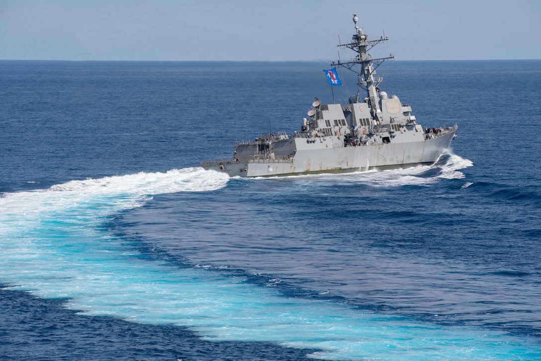 A ship turns to the right while transiting a body of water.