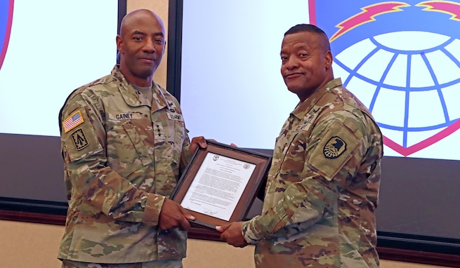 U.S. Army Space and Missile Defense Command's Commanding General, Lt. Gen. Sean Gainey (left), presents the charter for Army Capability Manager for Space and High Altitude to incoming ACM SHA, Col. Princeton Wright (right), at SMDC's Redstone Arsenal, Alabama, headquarters, June 28, 2024. (U.S. Army photo by Ronald C. Bailey)