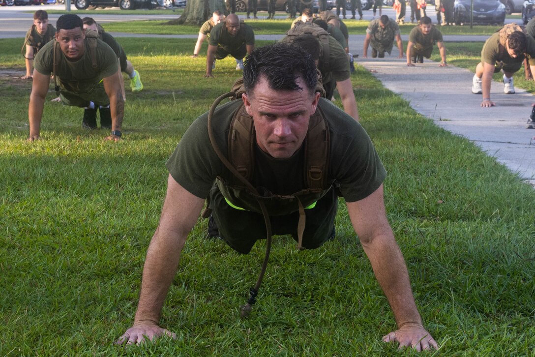 U.S. Marine Corps Sgt. Sean Rodgers, small arms repair technician with II Marine Expeditionary Force Support Battalion, II MEF Information Group, does pushups after a unit physical training event at Marine Corps Base Camp Lejeune, North Carolina, July 3, 2024. II MSB conducted a unit run to boost morale and enhance unit cohesion prior to the Independence Day holiday weekend. (U.S. Marine Corps photo by Lance Cpl. Christian Alston)