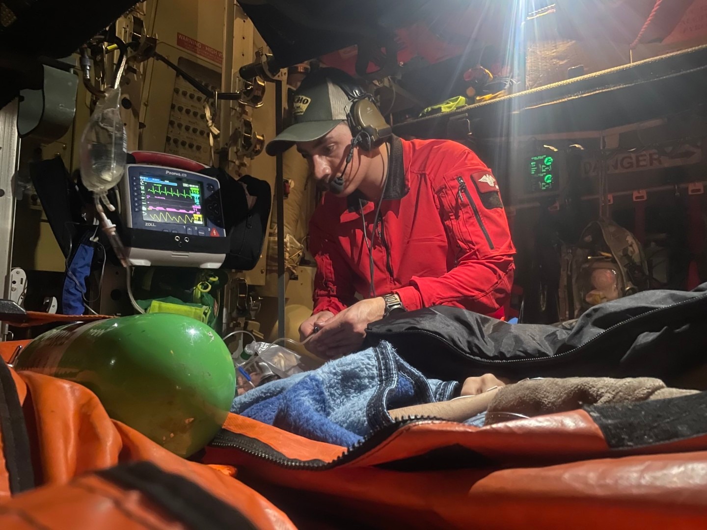 An Alaska Air National Guard Guardian Angel cares for a critically ill 22-year-old man rescued from a ship in the Gulf of Alaska June 15, 2024.