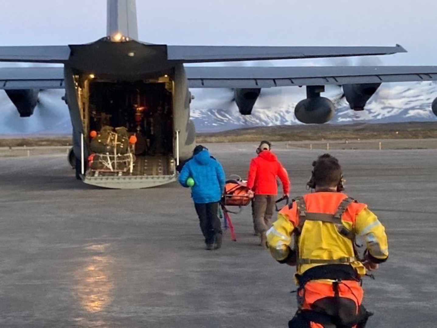 A critically injured mariner rescued from a vessel in the Gulf of Alaska and hoisted to a hovering Alaska Air National Guard helicopter is moved to an HC-130J Combat King II aircraft in Cold Bay, Alaska, to be taken to an ambulance at Joint Base Elmendorf-Richardson June 15, 2024. The 22-year-old man made a full recovery.